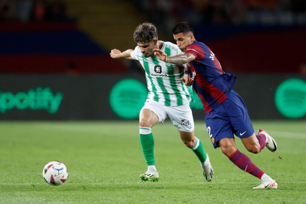 BARCELONA, SPAIN - SEPTEMBER 16: (L-R) Abde Ezzalzouli of Real Betis, Joao Cancelo of FC Barcelona during the LaLiga EA Sports match between FC Barcelona v Real Betis Sevilla at the Lluis Companys Olympic Stadium on September 16, 2023 in Barcelona Spain.