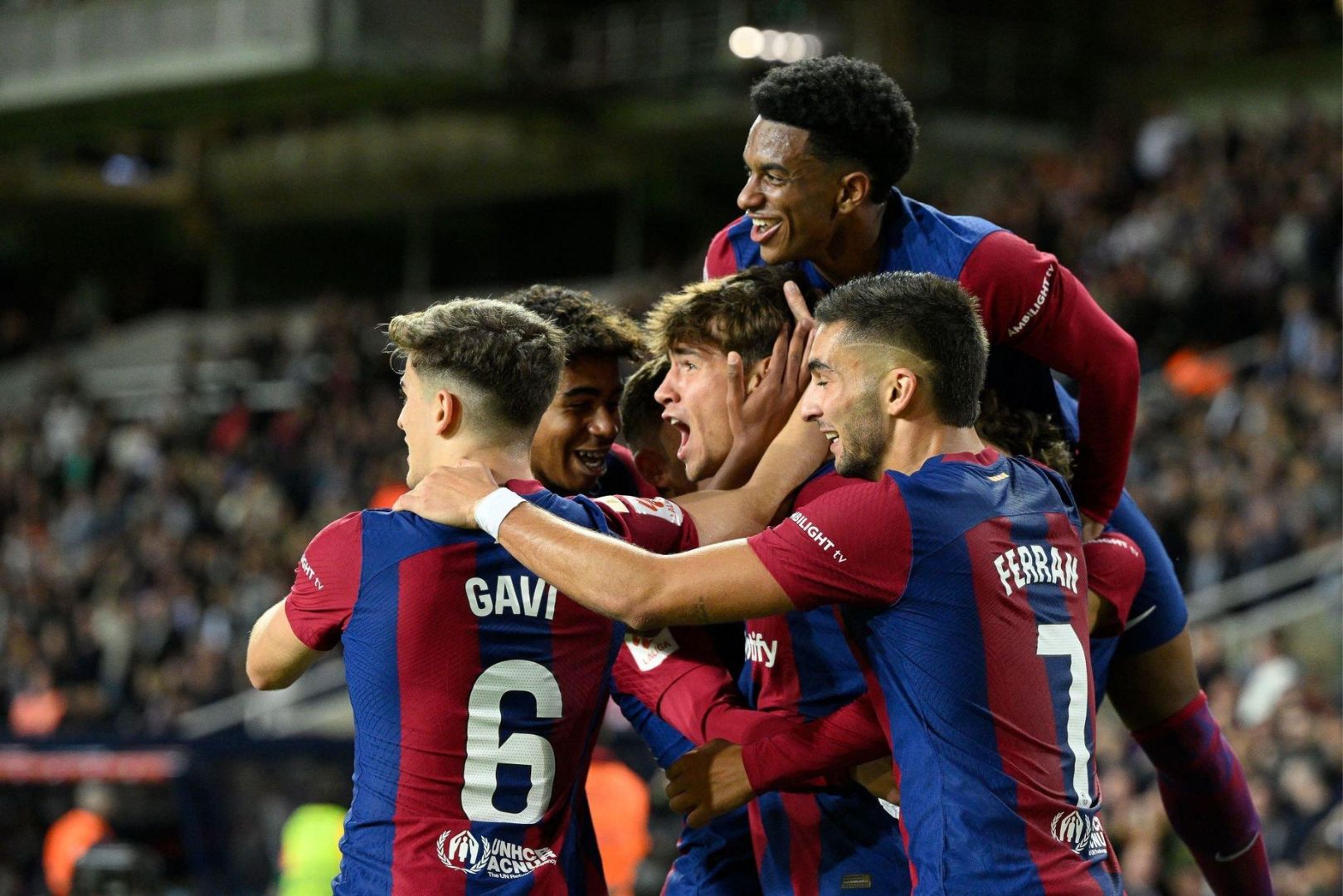 Barcelona's Spanish forward #38 Marc Guiu ( La Masia gradudate ) celebrates with teammates after scoring his team's first goal during the Spanish league football match between FC Barcelona and Athletic Club Bilbao at the Estadi Olimpic Lluis Companys in Barcelona on October 22, 2023.