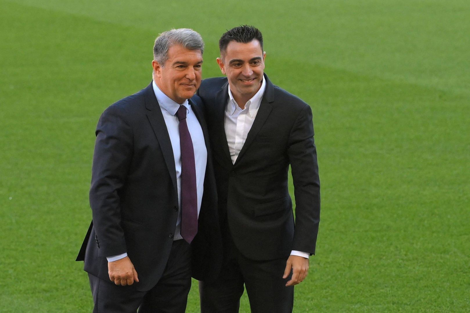 Newly-appointed FC Barcelona's Spanish coach Xavi Hernandez (R) poses with FC Barcelona's Spanish president Joan Laporta during his presentation ceremony at the Camp Nou stadium in Barcelona on November 8, 2021.