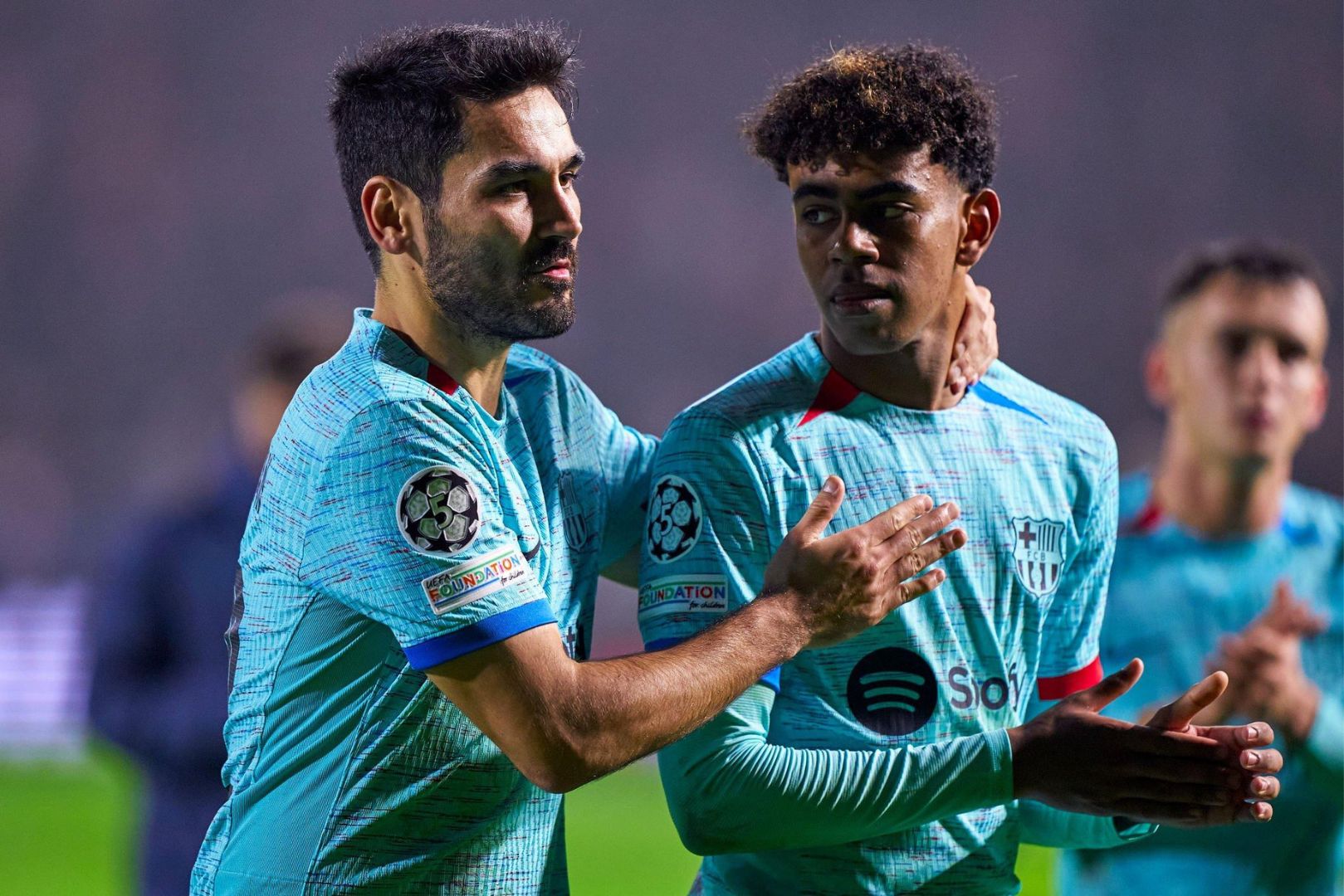 ANTWERPEN, BELGIUM - DECEMBER 13: Ilkay Gundogan and Lamine Yamal of FC Barcelona acknowledge the fans after the Group H - UEFA Champions League match between Royal Antwerp FC and FC Barcelona at Bosuilstadion on December 13, 2023 in Antwerpen, Belgium.