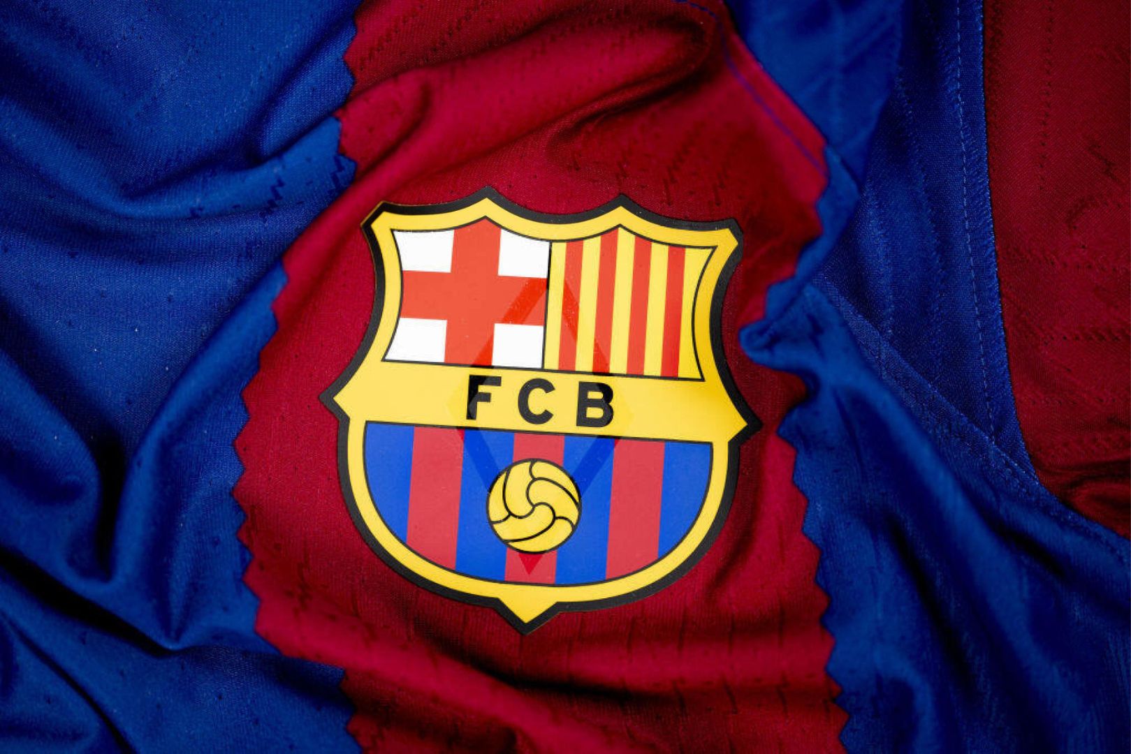 NYON, SWITZERLAND - NOVEMBER 23: A detailed view of the badge of FC Barcelona on the jersey during the UEFA Champions League 2023/24 Group Stage Teams Jerseys Shoot at The House of the European Football, on November 23, 2023, in Nyon, Switzerland