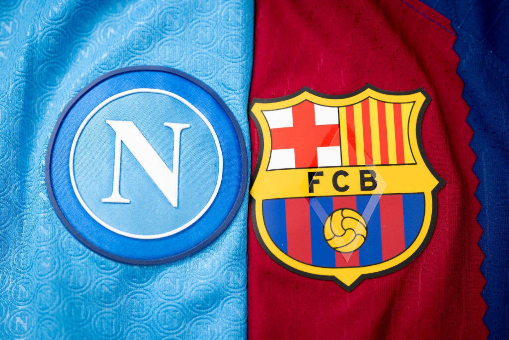 NYON, SWITZERLAND - DECEMBER 18: A detailed view of the badges of SSC Napoli and FC Barcelona during a photo shoot after the UEFA Champions League 2023/24 Round of 16 Draw at the UEFA Headquarters, the House of European Football, on December 18, 2023 in Nyon, Switzerland