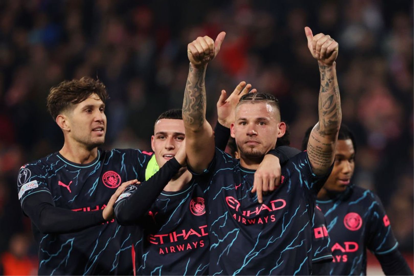 BELGRADE, SERBIA - DECEMBER 13: Kalvin Phillips of Manchester City celebrates with teammates John Stones and Phil Foden after scoring their team's third goal during the UEFA Champions League match between FK Crvena zvezda and Manchester City at Stadion Rajko Mitić on December 13, 2023 in Belgrade, Serbia.