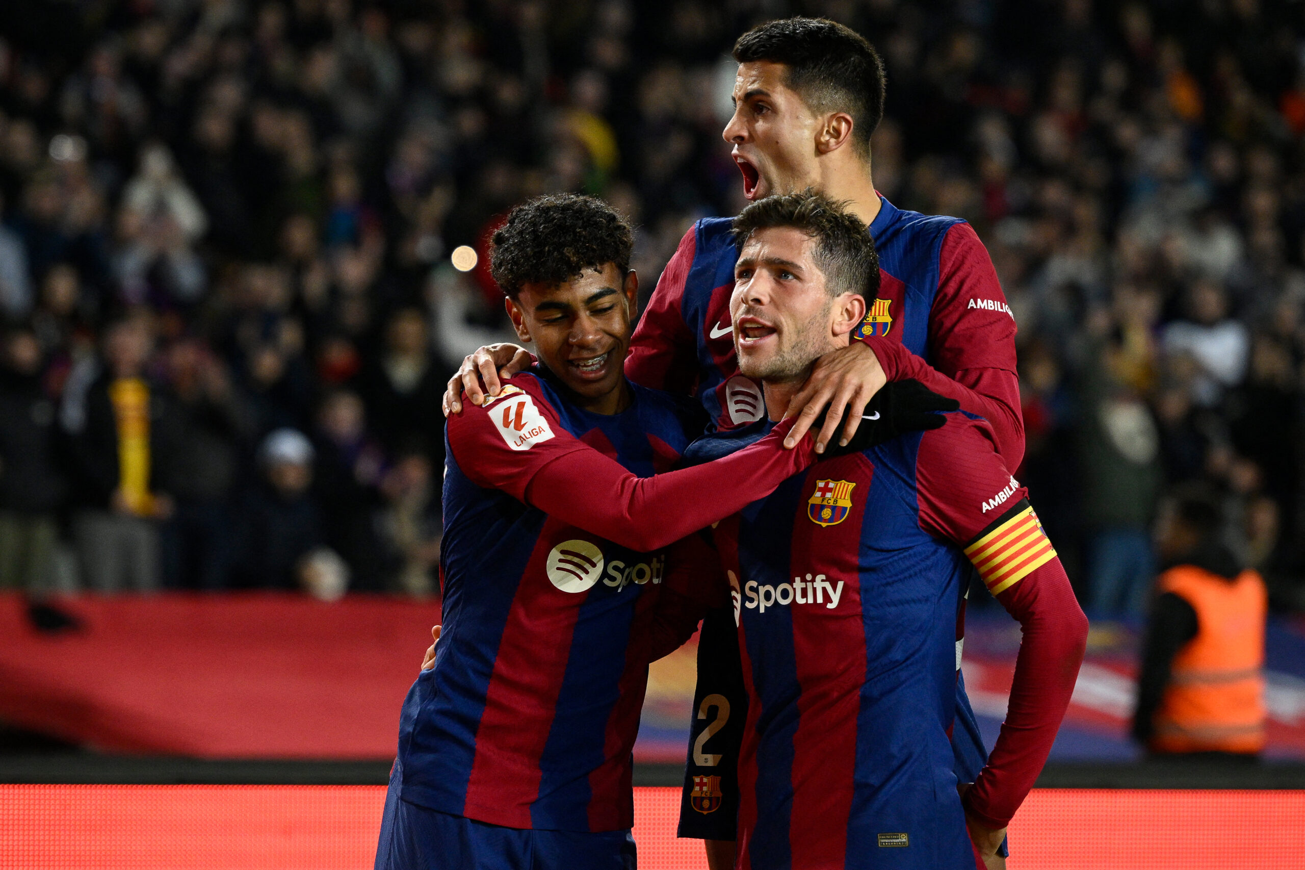 Barcelona's Spanish midfielder #20 Sergi Roberto celebrates with teammates after scoring his team's third goal during the Spanish league football match between FC Barcelona and UD Almeria at the Estadi Olimpic Lluis Companys in Barcelona on December 20, 2023.