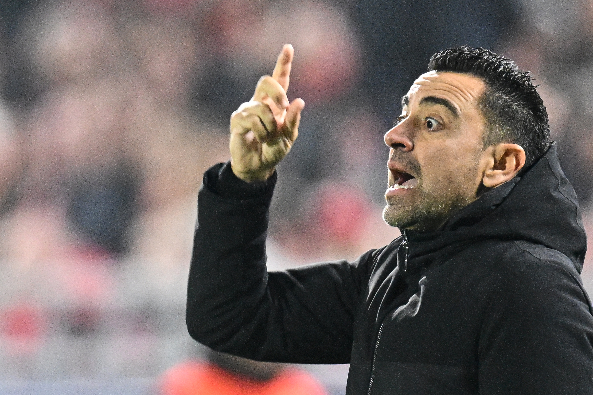 Barcelona's Spanish coach Xavi gestures during the UEFA Champions League Group H football match between Royal Antwerp FC and FC Barcelona at the Bosuilstadion in Antwerp, on December 13, 2023.