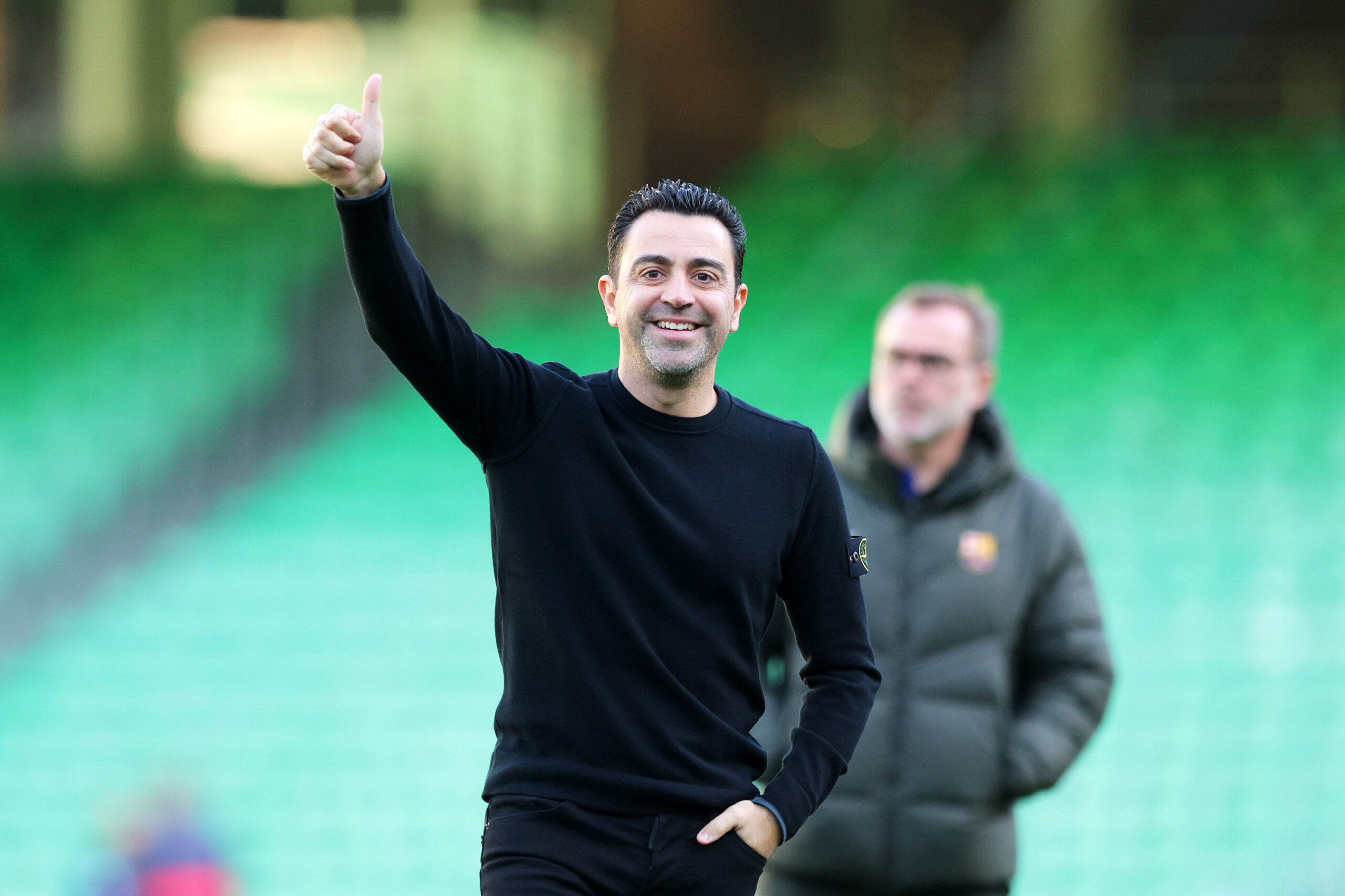 SEVILLE, SPAIN - JANUARY 21: Xavi, Head Coach of FC Barcelona, reacts as he inspects the pitch prior to the LaLiga EA Sports match between Real Betis and FC Barcelona at Estadio Benito Villamarin on January 21, 2024 in Seville, Spain.