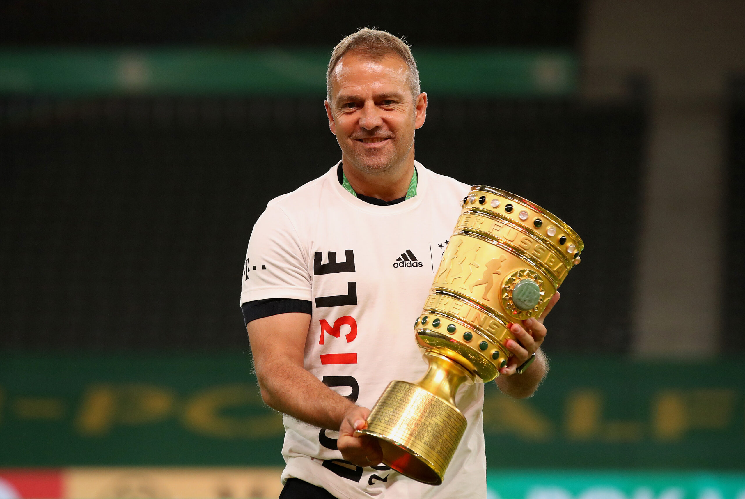 BERLIN, GERMANY - JULY 04: Head coach Hansi Flick of FC Bayern Muenchen poses with the trophy in celebration after the DFB Cup final match between Bayer 04 Leverkusen and FC Bayern Muenchen at Olympiastadion on July 04, 2020 in Berlin, Germany.