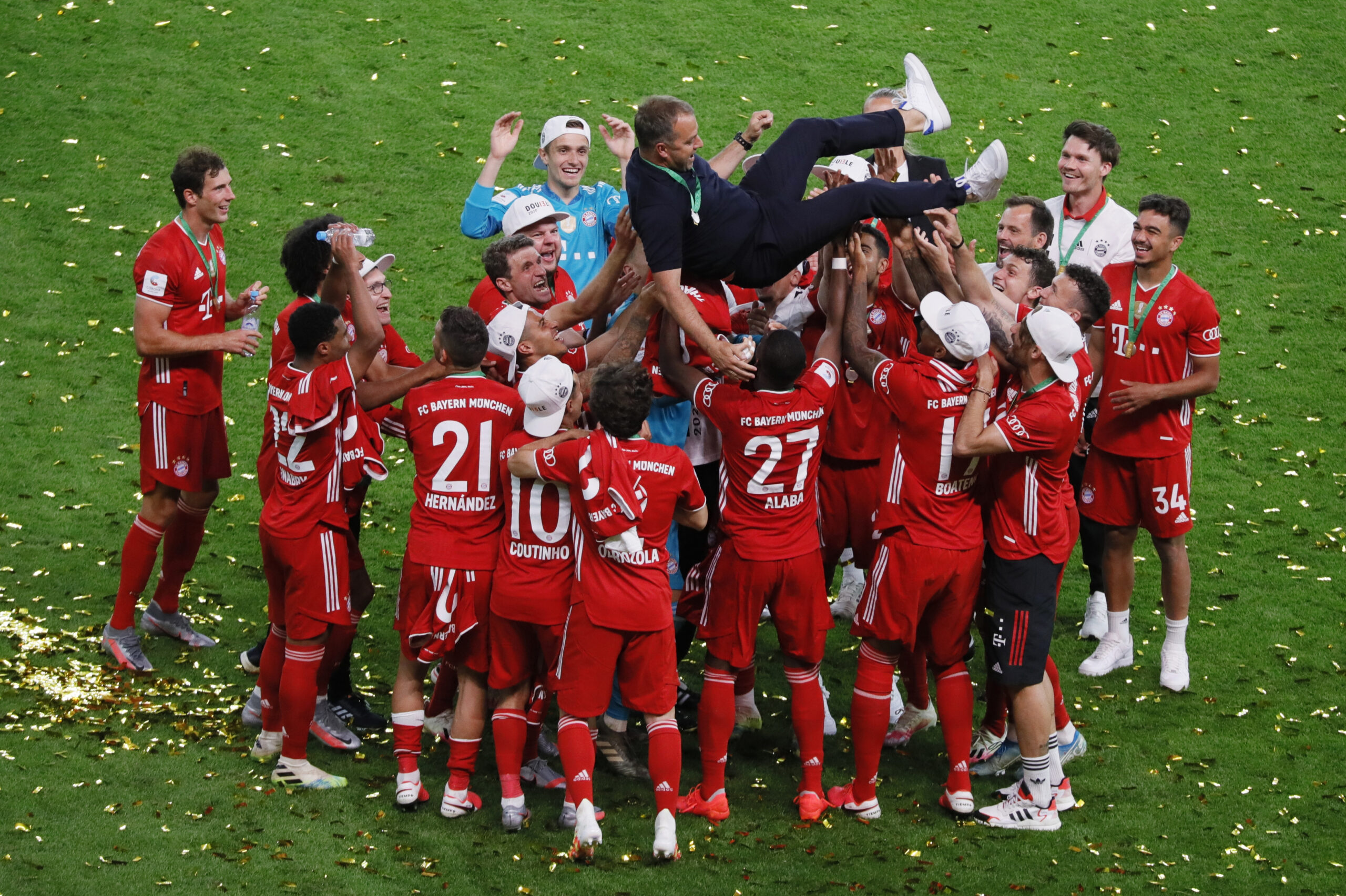 BERLIN, GERMANY - JULY 04: Hansi Flick, Manager of Bayern Munich is lifted in the air by his players during the DFB Cup final match between Bayer 04 Leverkusen and FC Bayern Muenchen at Olympiastadion on July 4, 2020 in Berlin, Germany.