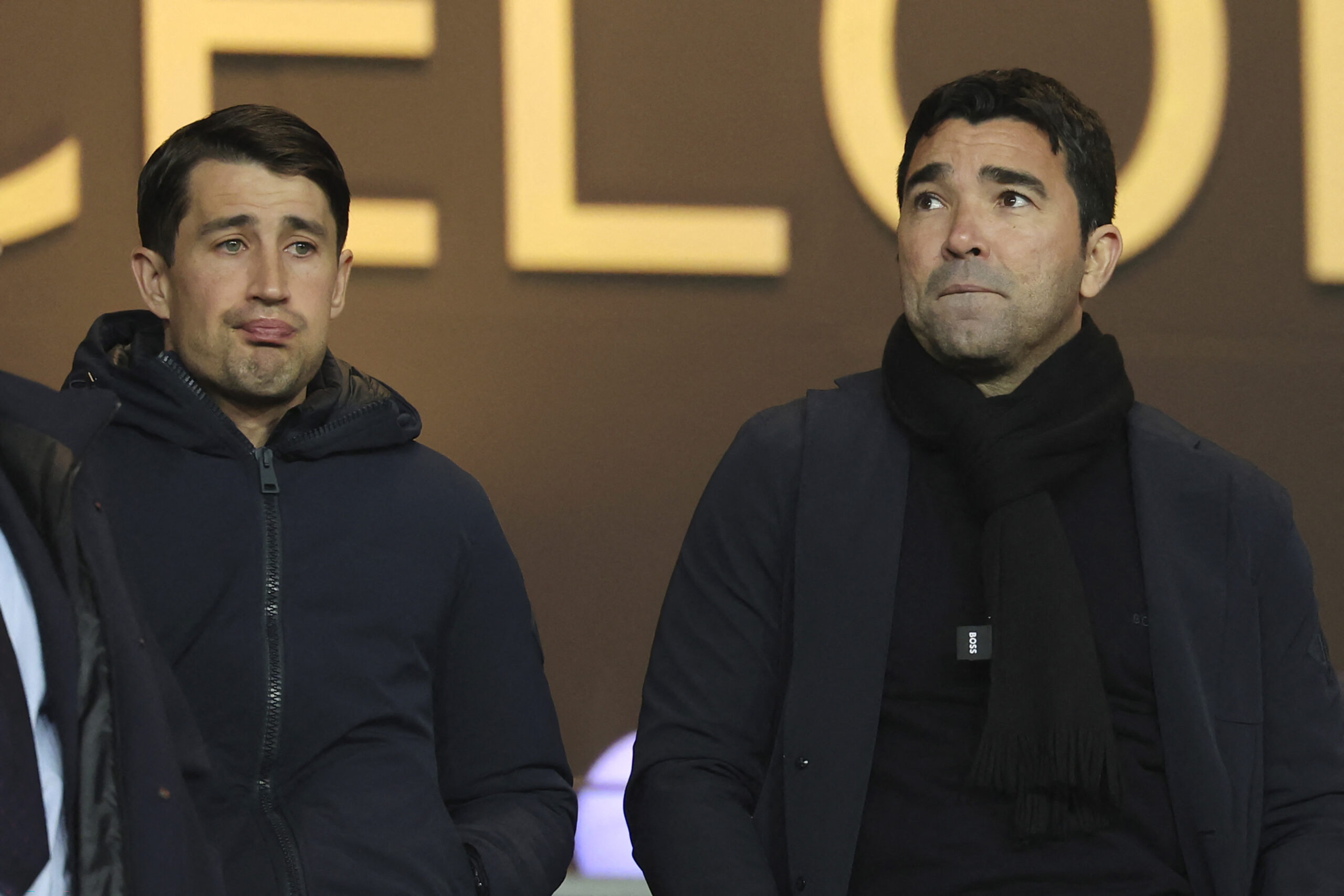 Former footballer Bojan Krkic (L) and Barcelona's Sports Director Anderson de Souza Deco wait for the start of the the Spanish league football match between FC Barcelona and CA Osasuna at the Estadi Olimpic Lluis Companys in Barcelona on January 31, 2024.