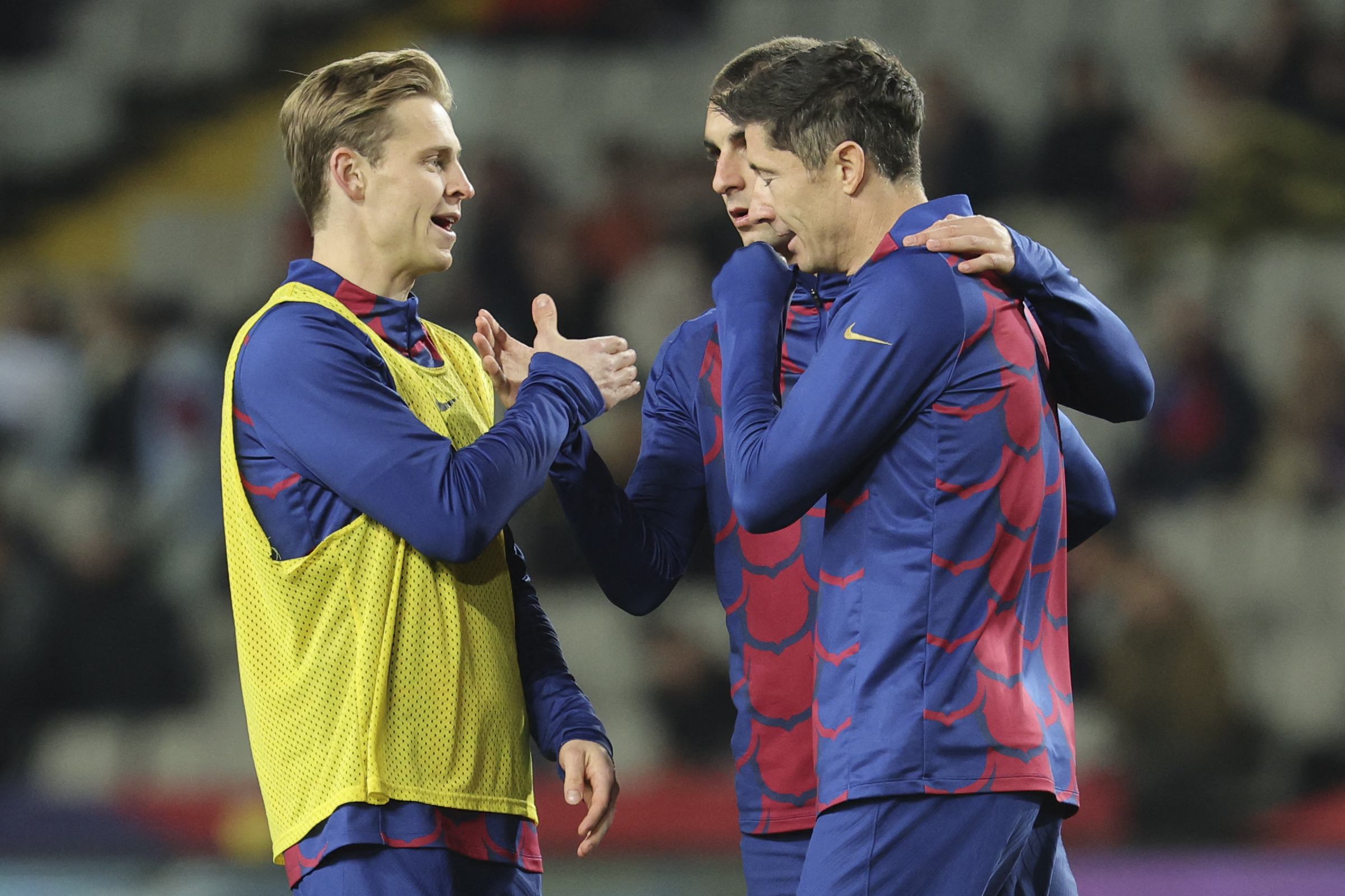 Barcelona's Dutch midfielder #21 Frenkie de Jong (L), Barcelona's Spanish forward #07 Ferran Torres and Barcelona's Polish forward #09 Robert Lewandowski (R) talk together during the warming-up before the Spanish league football match between FC Barcelona and CA Osasuna at the Estadi Olimpic Lluis Companys in Barcelona on January 31, 2024.