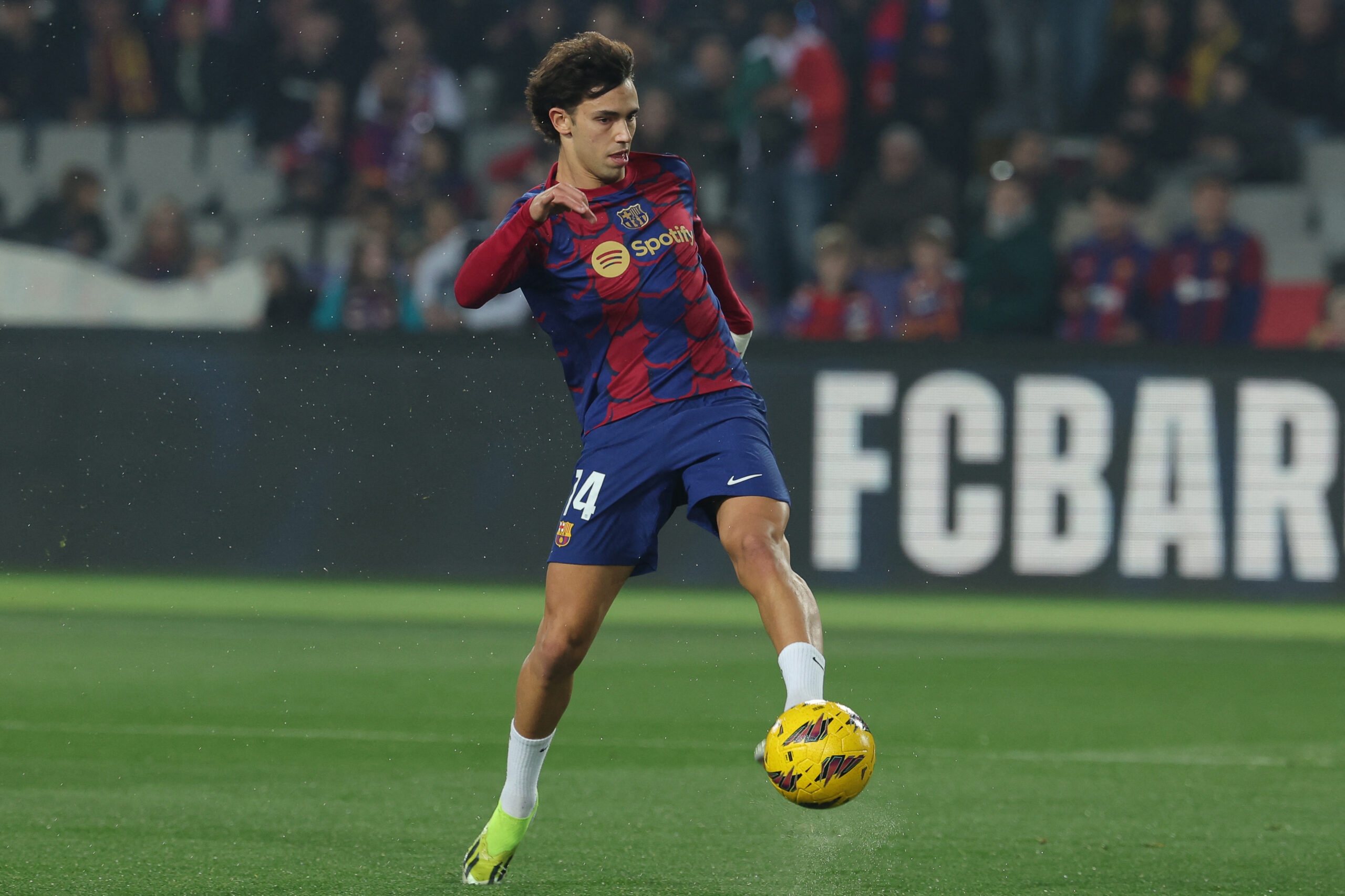 Barcelona's Portuguese forward #14 Joao Felix warms up before the start of during the Spanish league football match between FC Barcelona and Villarreal CF at the Estadi Olimpic Lluis Companys in Barcelona on January 27, 2024.