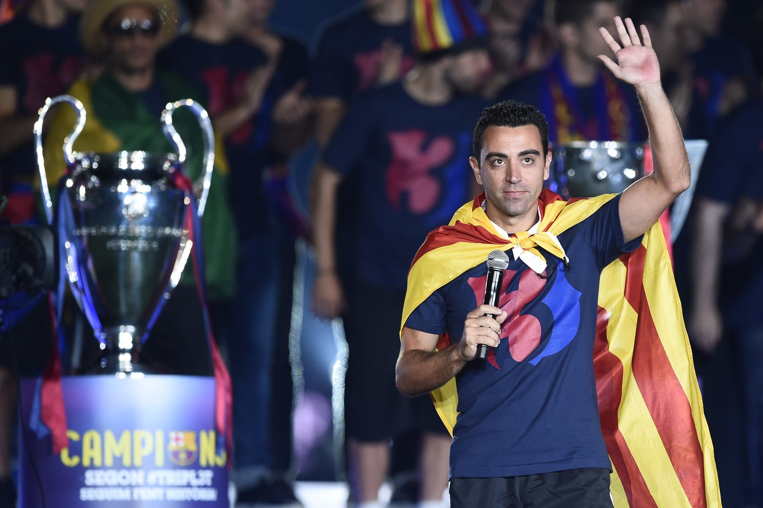 Barcelona's midfielder Xavi Hernandez waves as he takes part in the celebrations held for their victory over Juventus, one day after the UEFA Champions League final football, at the Camp Nou stadium in Barcelona on June 7, 2015. Luis Suarez and Neymar scored second-half goals to give Barcelona a 3-1 Champions League final victory over Juventus on June 6, 2015 as the Spaniards became the first team to twice win the European treble.