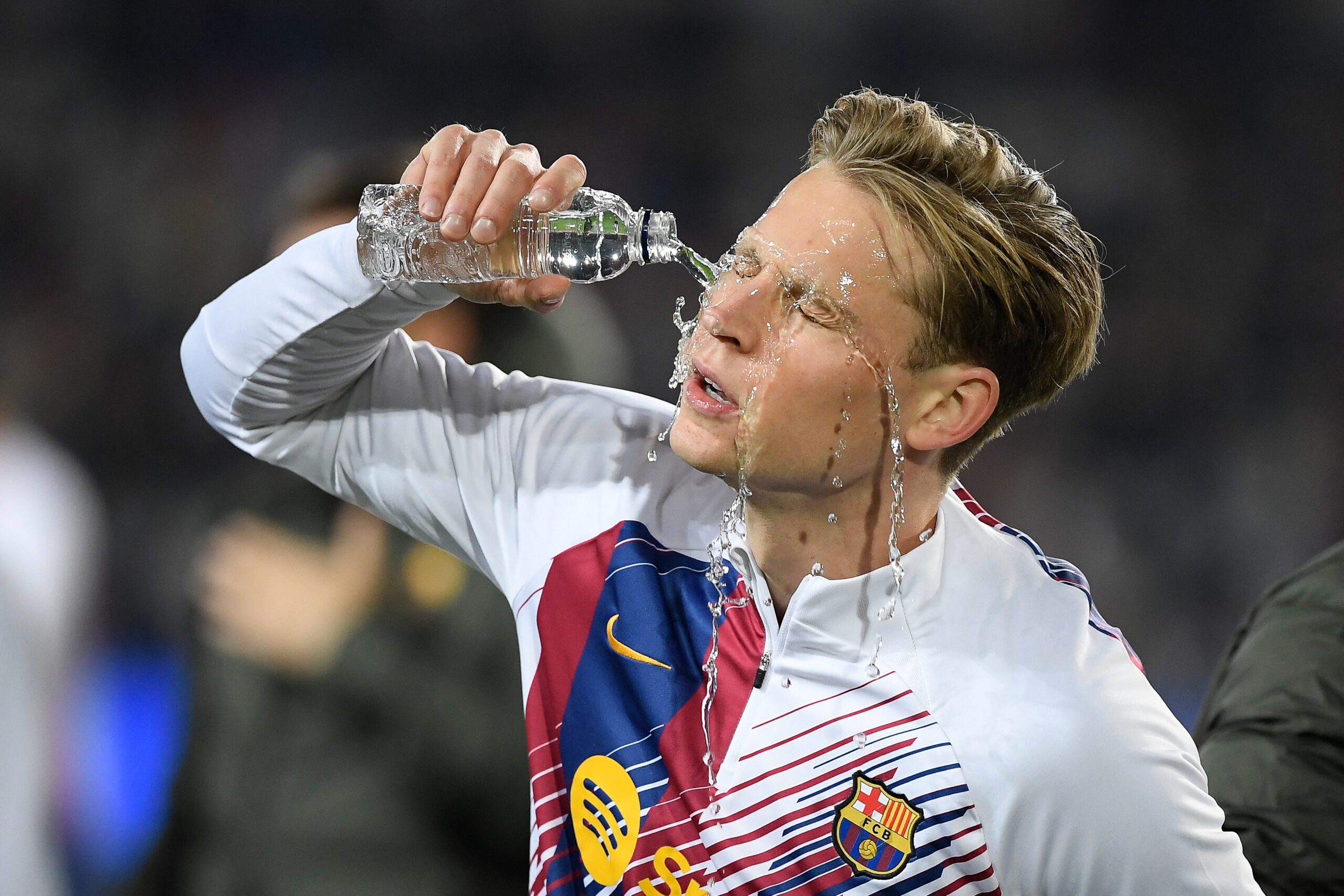 Barcelona's Dutch midfielder #21 Frenkie de Jong pours water on his face before the start of the UEFA Champions League first round group H football match between FC Barcelona and FC Porto at the Estadi Olimpic Lluis Companys in Barcelona on November 28, 2023.