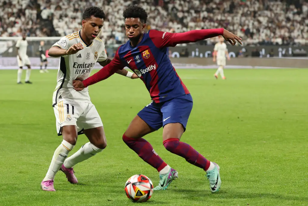 Real Madrid's Brazilian forward #11 Rodrygo and Barcelona's Spanish defender #03 Alejandro Balde vie for the ball during the Spanish Super Cup final football match between Real Madrid and Barcelona at the Al-Awwal Park Stadium in Riyadh, on January 14, 2024.