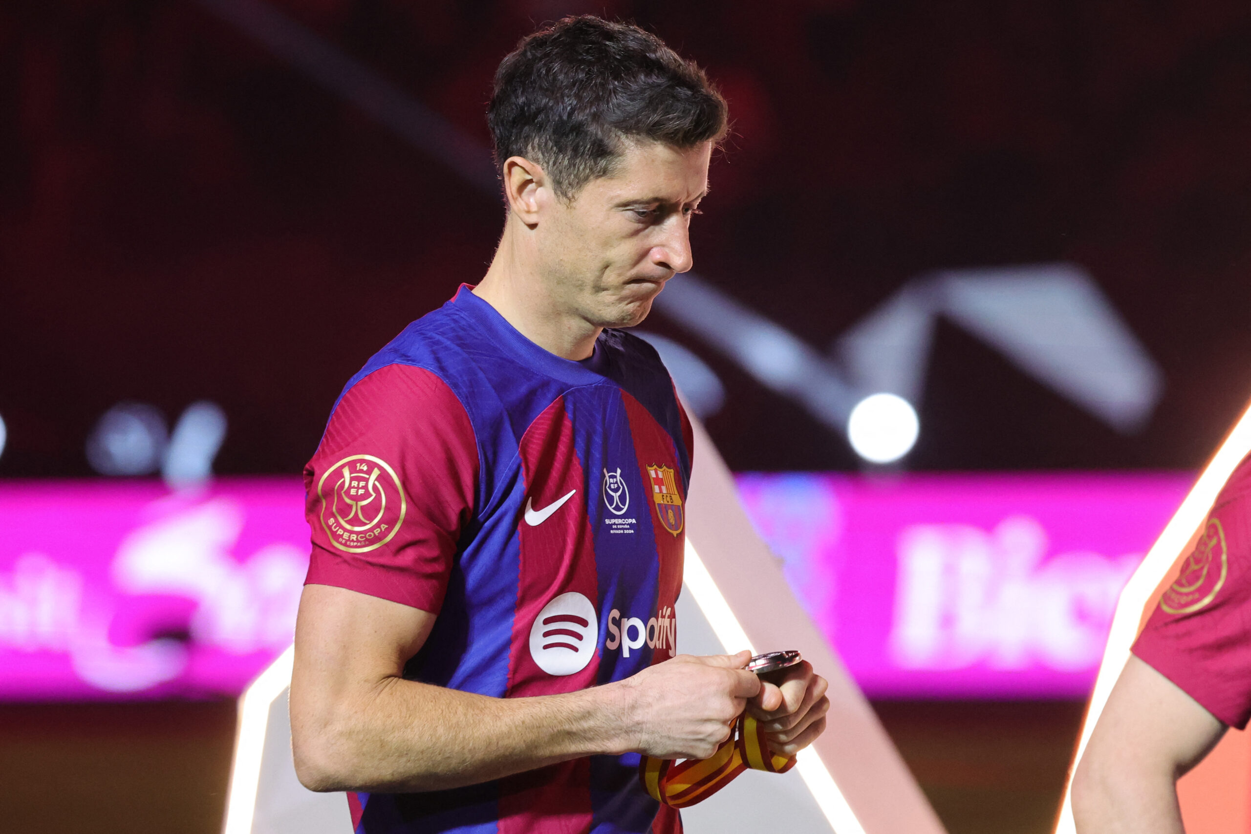 Barcelona's Polish forward #09 Robert Lewandowski walks during the medal ceremony after the Spanish Super Cup final football match between Real Madrid and Barcelona at the Al-Awwal Park Stadium in Riyadh, on January 14, 2024.