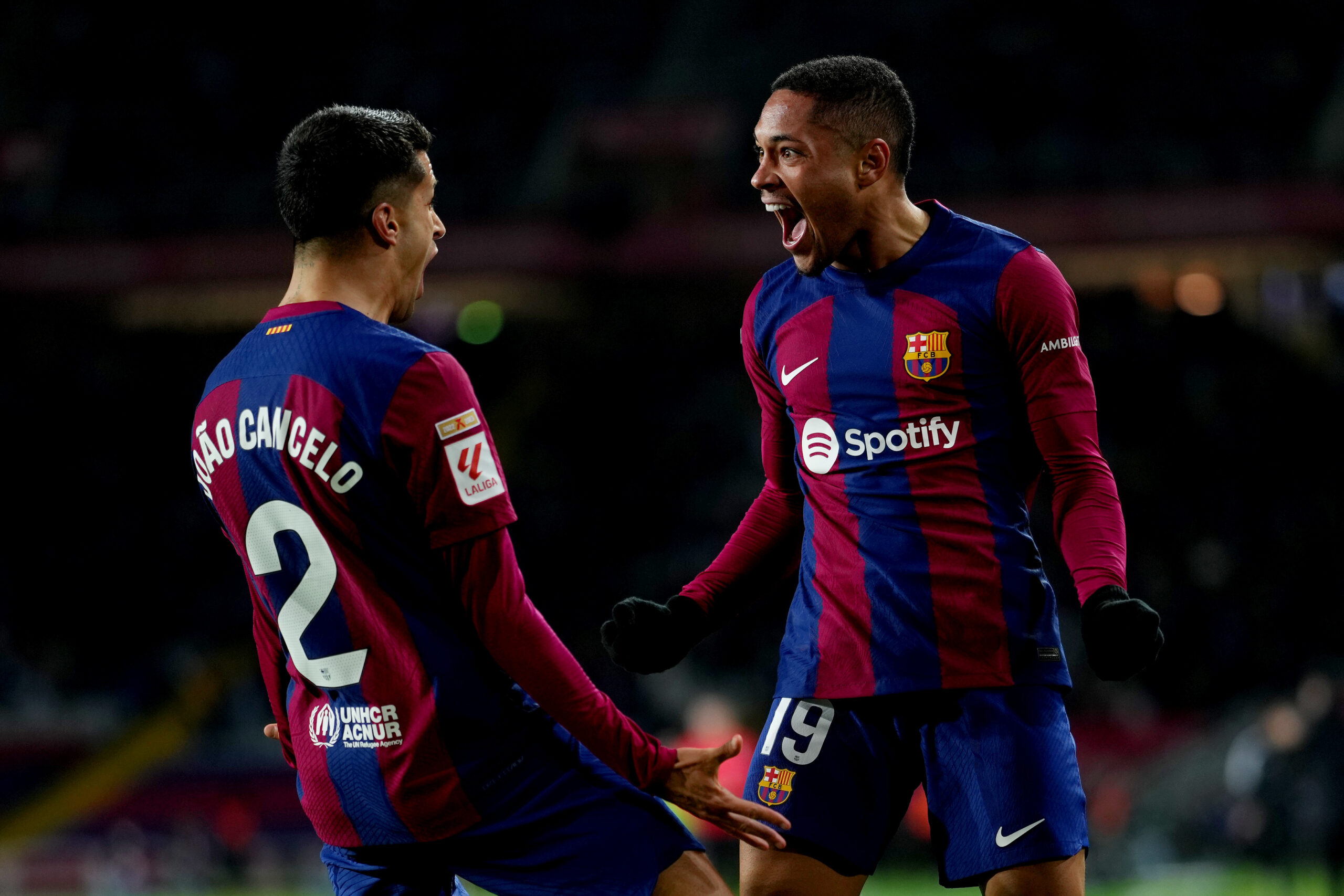 BARCELONA, SPAIN - JANUARY 31: Vitor Roque of FC Barcelona celebrates scoring his team's first goal with teammate Joao Cancelo during the LaLiga EA Sports match between FC Barcelona and CA Osasuna at Estadi Olimpic Lluis Companys on January 31, 2024 in Barcelona, Spain.