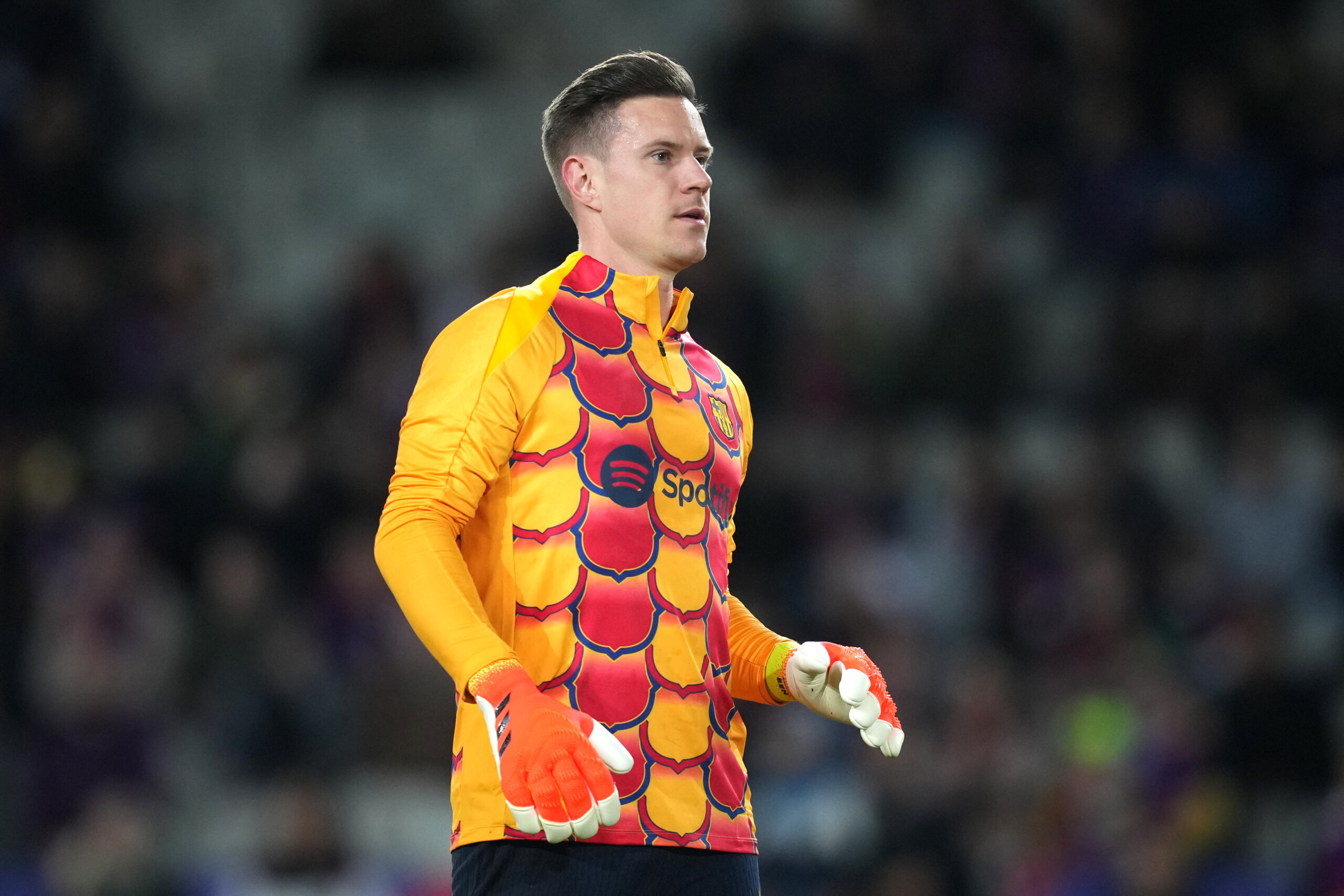 BARCELONA, SPAIN - FEBRUARY 11: Marc-Andre ter Stegen of FC Barcelona warms up whilst wearing the Chinese New Year collection warm up shirt prior to the LaLiga EA Sports match between FC Barcelona and Granada CF at Estadi Olimpic Lluis Companys on February 11, 2024 in Barcelona, Spain.