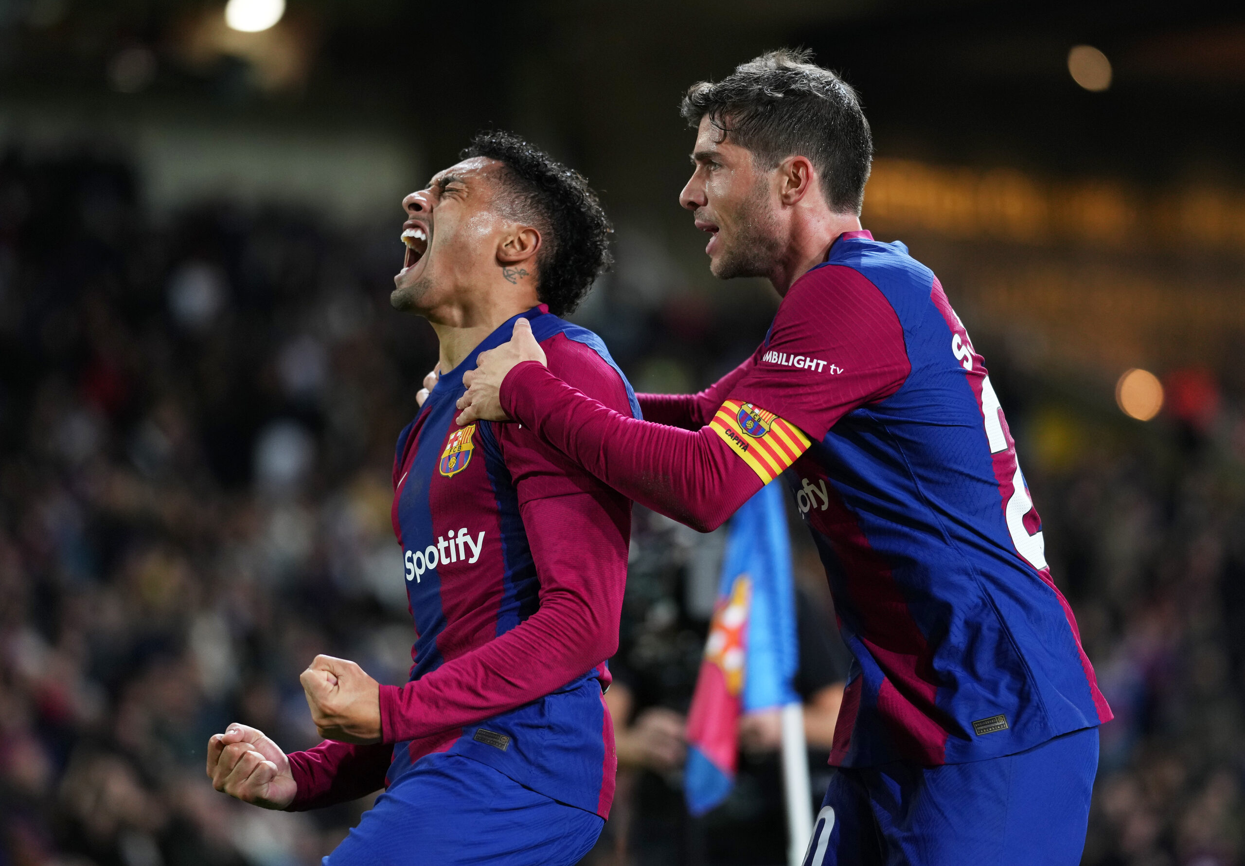 BARCELONA, SPAIN - DECEMBER 20: Raphinha of FC Barcelona celebrates with teammate Sergi Roberto after scoring their team's first goal during the LaLiga EA Sports match between FC Barcelona and UD Almeria at Estadi Olimpic Lluis Companys on December 20, 2023 in Barcelona, Spain.