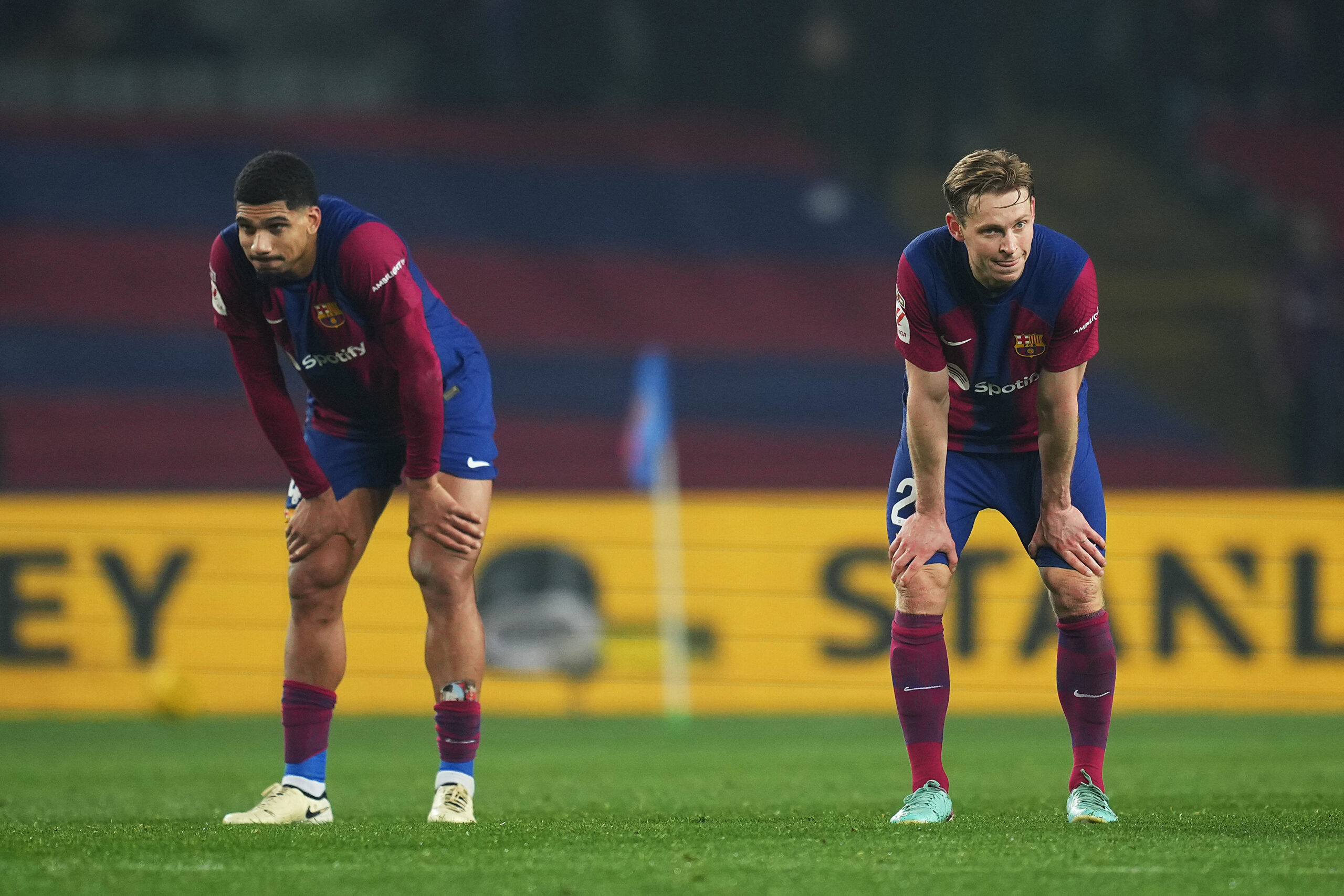 BARCELONA, SPAIN - JANUARY 27: Ronald Araujo and Frenkie de Jong of FC Barcelona look dejected at full-time following the teams defeat in the LaLiga EA Sports match between FC Barcelona and Villarreal CF at Estadi Olimpic Lluis Companys on January 27, 2024 in Barcelona, Spain.