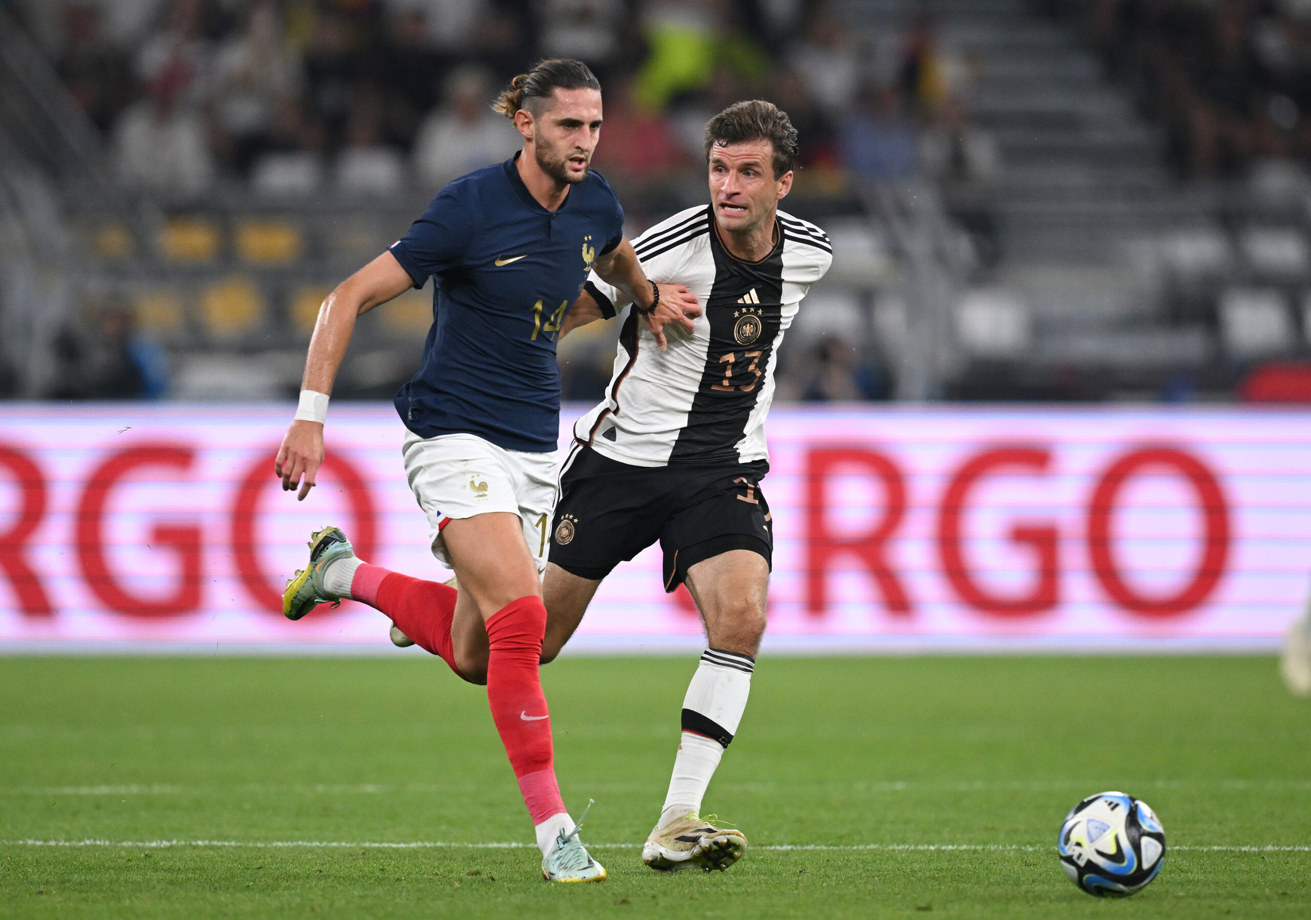 DORTMUND, GERMANY - SEPTEMBER 12: Thomas Müller of Germany is challenged by Adrien Rabiot of France during the international friendly match between Germany and France at Signal Iduna Park on September 12, 2023 in Dortmund, Germany.