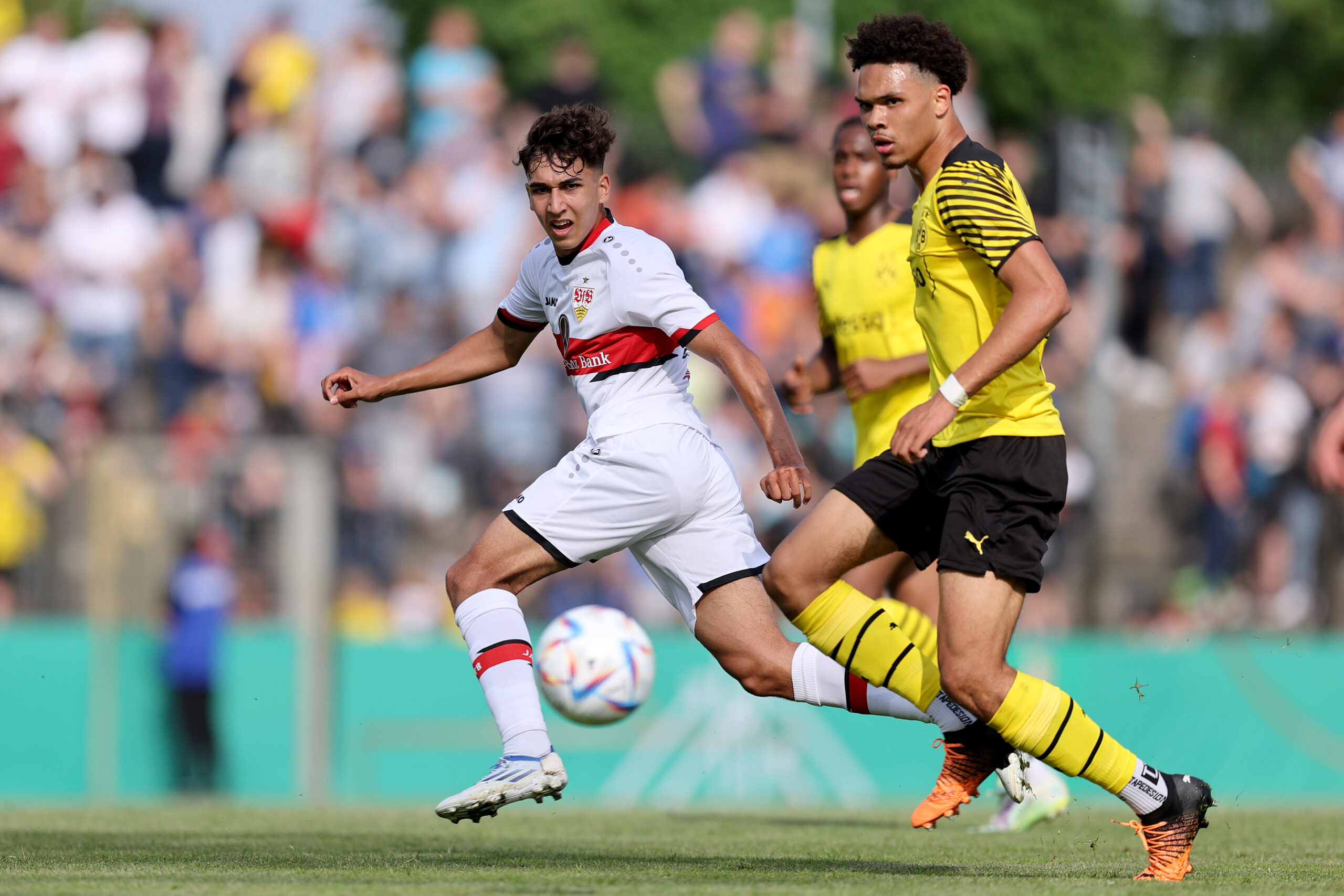 POTSDAM, GERMANY - MAY 20: Raul Paula (L) of VfB Stuttgart U19 is challenged by Pharrell Nnamdi Collins (R) of Borussia Dortmund U19 during the DFB Junior Cup Final match between VfB Stuttgart U19 and Borussia Dortmund U19 at Karl-Liebknecht-Stadion on May 20, 2022 in Potsdam, Germany.