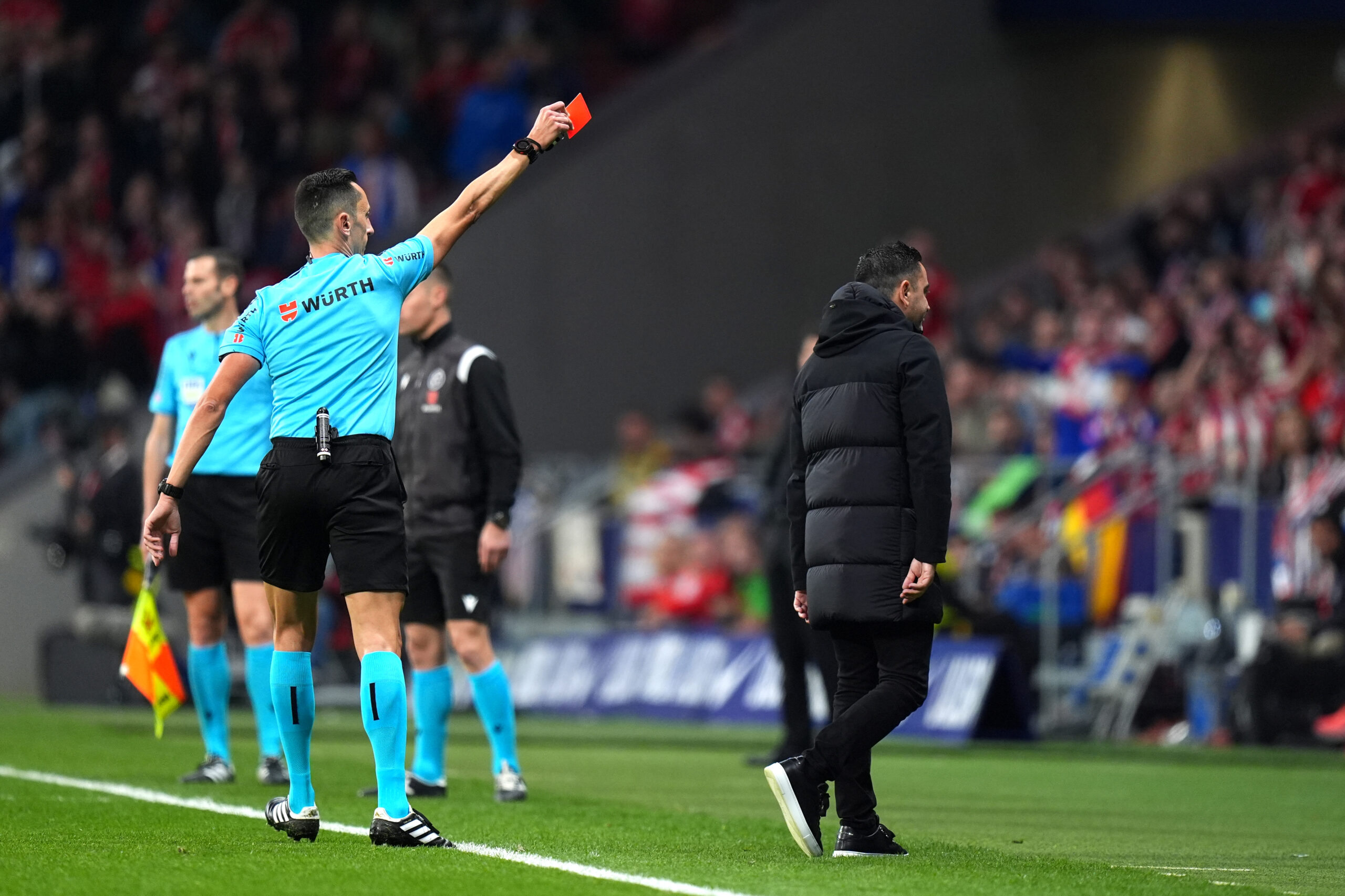 MADRID, SPAIN - MARCH 17: Match Referee Jose Maria Sanchez Martinez shows Xavi, Head Coach of FC Barcelona, a red card during the LaLiga EA Sports match between Atletico Madrid and FC Barcelona at Civitas Metropolitano Stadium on March 17, 2024 in Madrid, Spain.