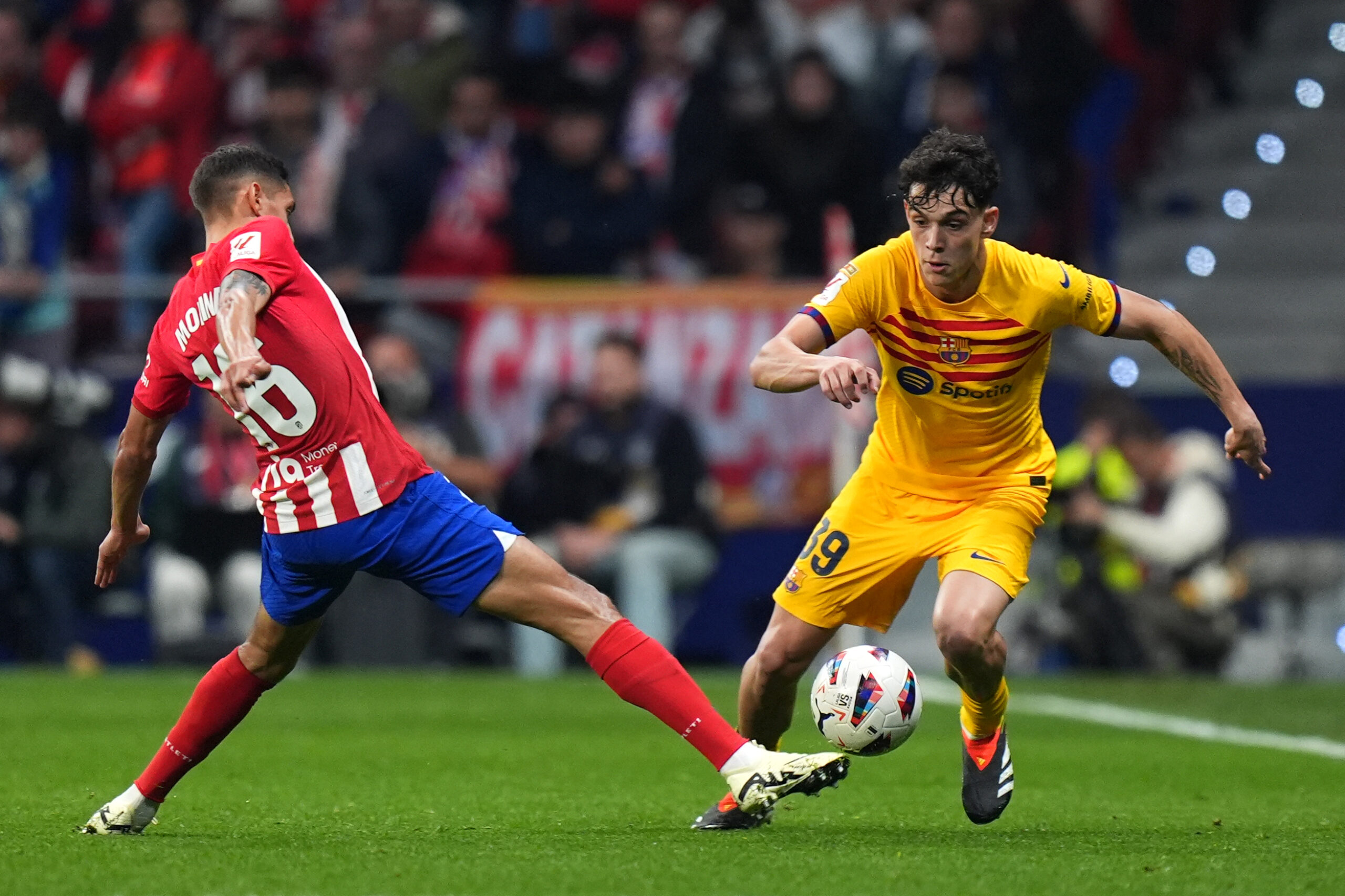 MADRID, SPAIN - MARCH 17: Hector Fort of FC Barcelona is challenged by Nahuel Molina of Atletico Madrid during the LaLiga EA Sports match between Atletico Madrid and FC Barcelona at Civitas Metropolitano Stadium on March 17, 2024 in Madrid, Spain.