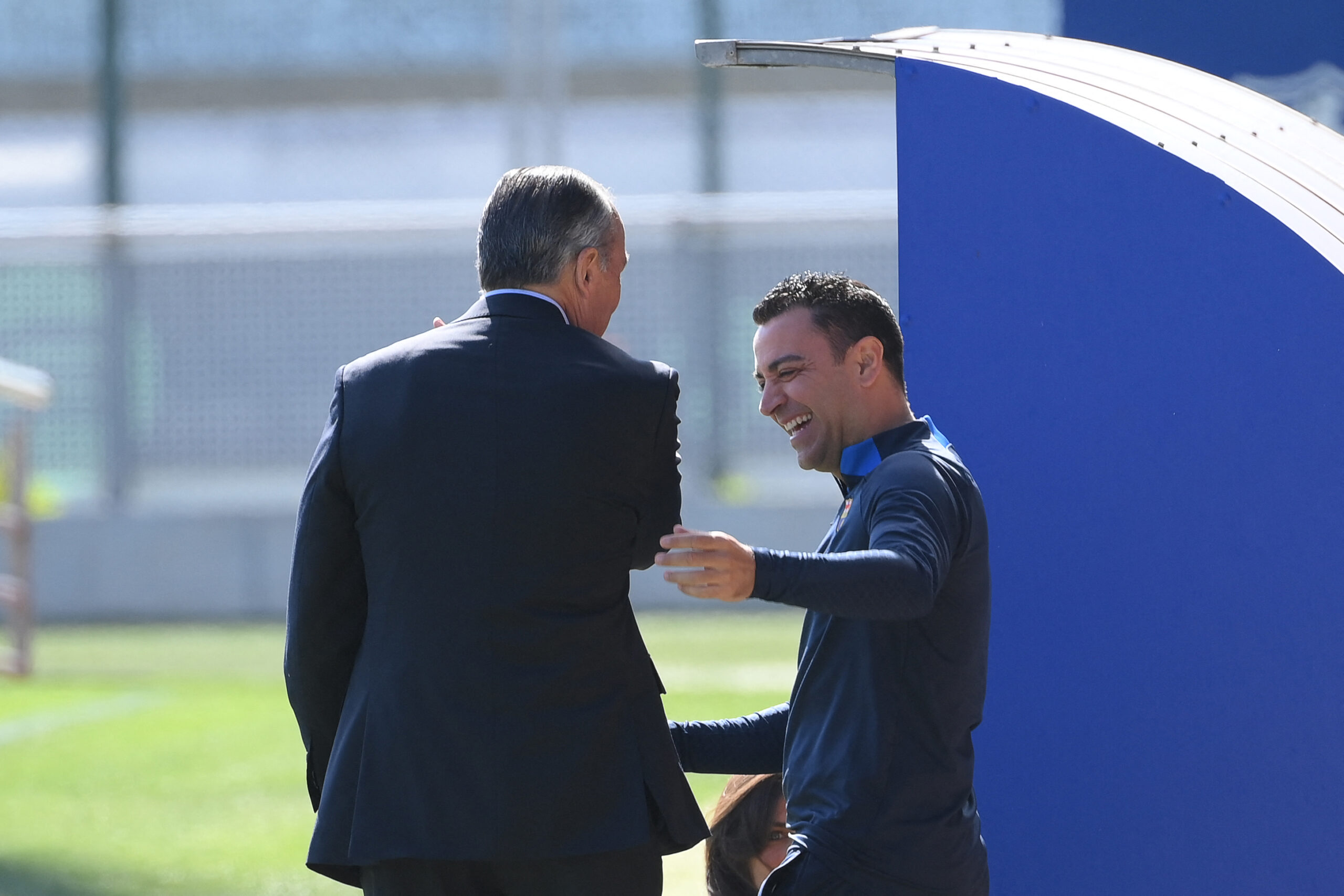 FC Barcelona's vice president Rafael Yuste (L) greets Barcelona's Spanish coach Xavi as he arrives for a training session at the Joan Gamper training ground in Sant Joan Despi, on April 4, 2023, on the eve of the Spanish Cup semi-final football match against Real Madrid.