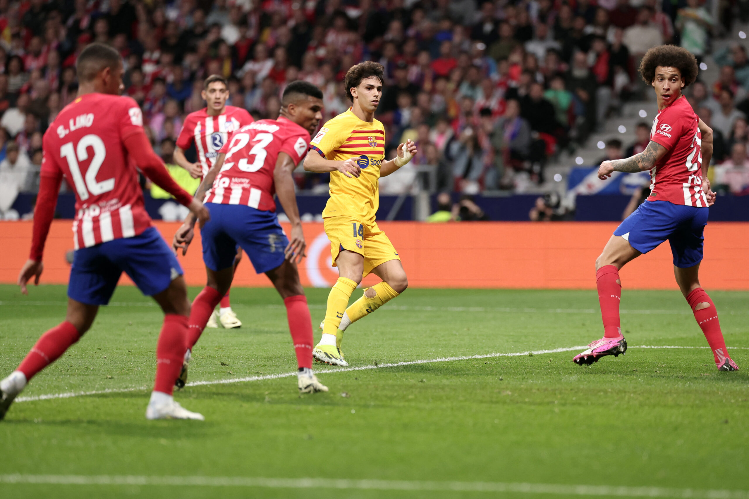 Barcelona's Portuguese forward #14 Joao Felix reacts after scoring the opening goal during the Spanish league football match between Club Atletico de Madrid and FC Barcelona at the Metropolitano stadium in Madrid on March 17, 2024.