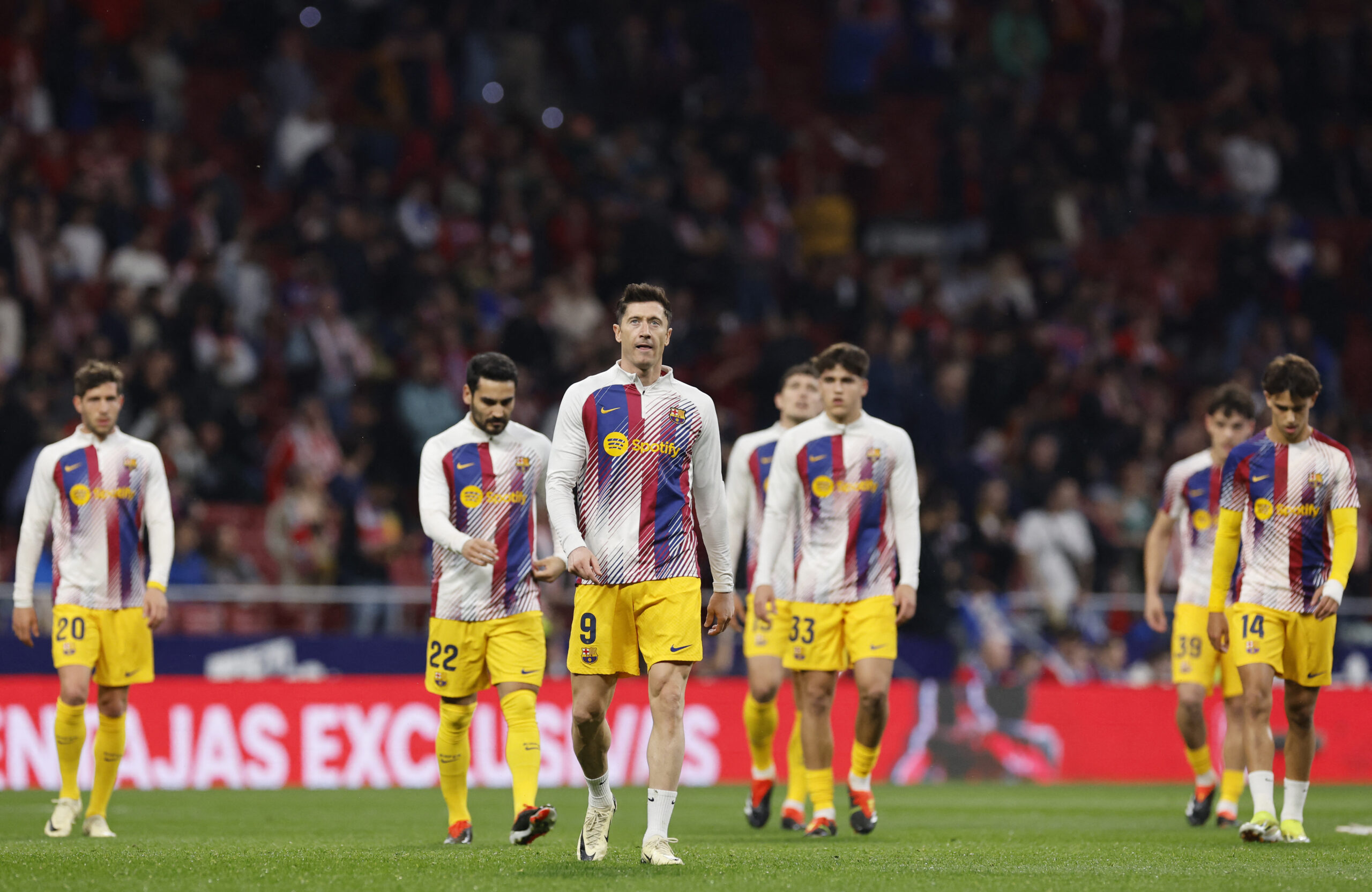 Barcelona's Polish forward #09 Robert Lewandowski (C) warms up with teammates before the Spanish league football match between Club Atletico de Madrid and FC Barcelona at the Metropolitano stadium in Madrid on March 17, 2024.