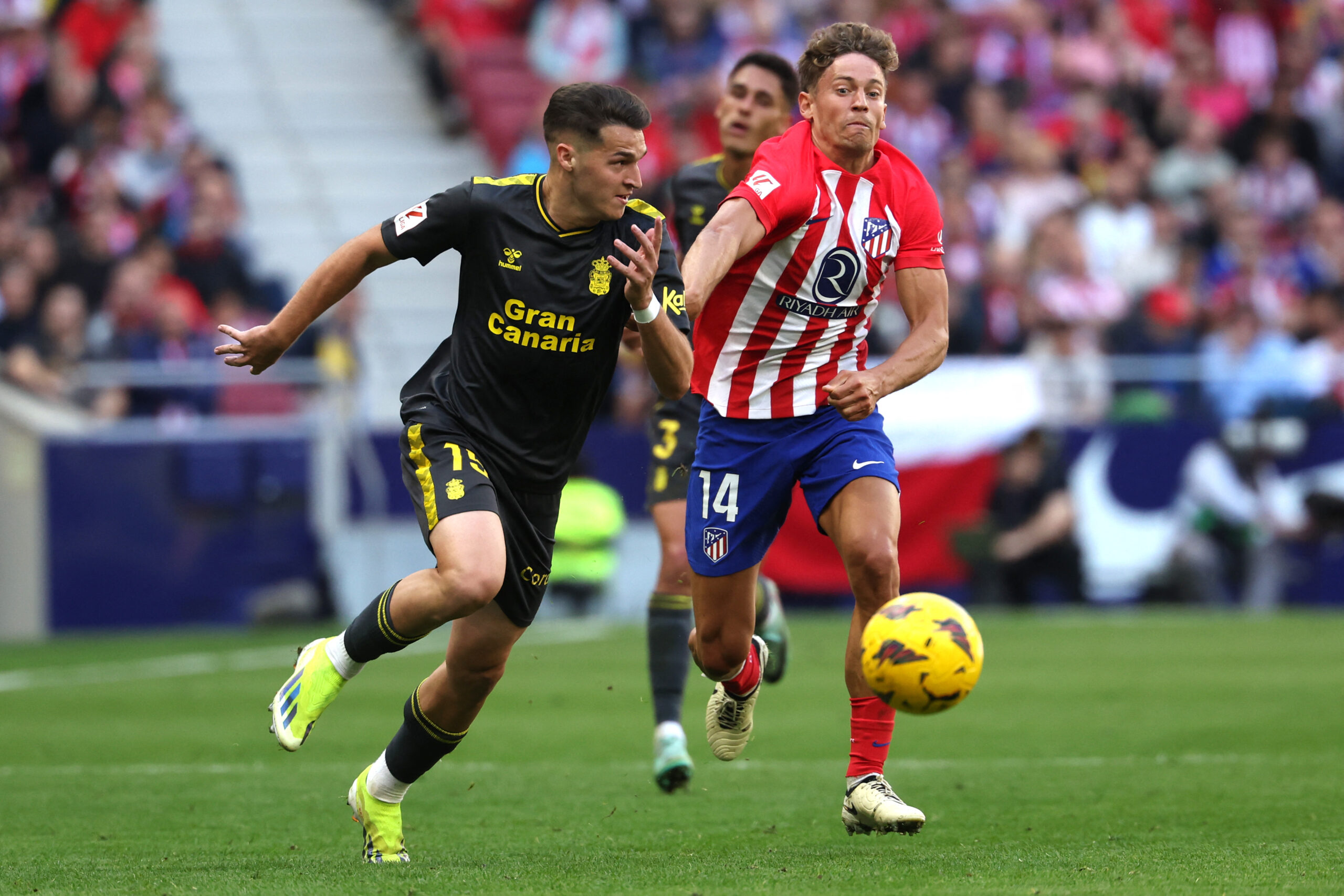 Las Palmas' Spanish defender #15 Mika Marmol is challenged by Atletico Madrid's Spanish midfielder #14 Marcos Llorente during the Spanish league football match between Club Atletico de Madrid and UD Las Palmas at the Metropolitano stadium in Madrid on February 17, 2024.