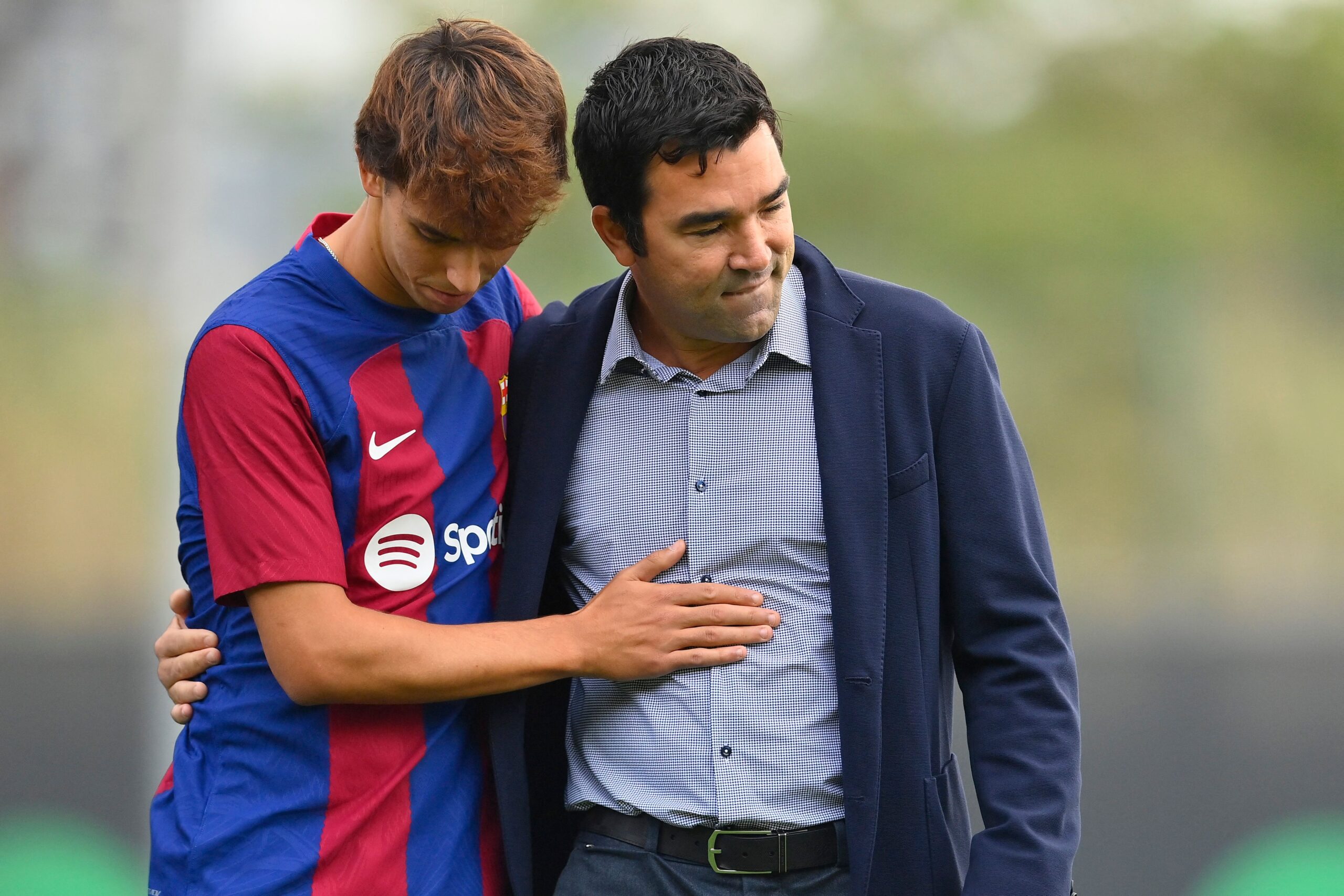 Portuguese forward Joao Felix (L) hugs FC Barcelona sports director Anderson de Souza Deco during his official presentation as new player of FC Barcelona at the Joan Gamper training ground in Sant Joan Despi, near Barcelona, on September 2, 2023. Barcelona signed Atletico Madrid forward Joao Felix and Manchester City defender Joao Cancelo on loan until the end of the season.