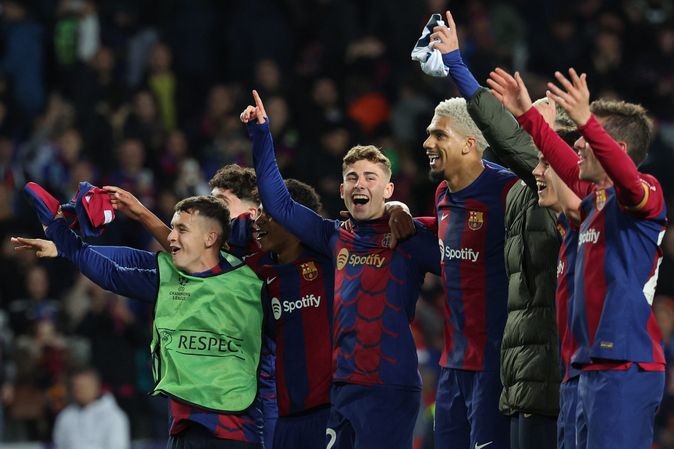 Barcelona players celebrate their win at the end of the UEFA Champions League last 16 second leg football match between FC Barcelona and SSC Napoli at the Estadi Olimpic Lluis Companys in Barcelona on March 12, 2024.