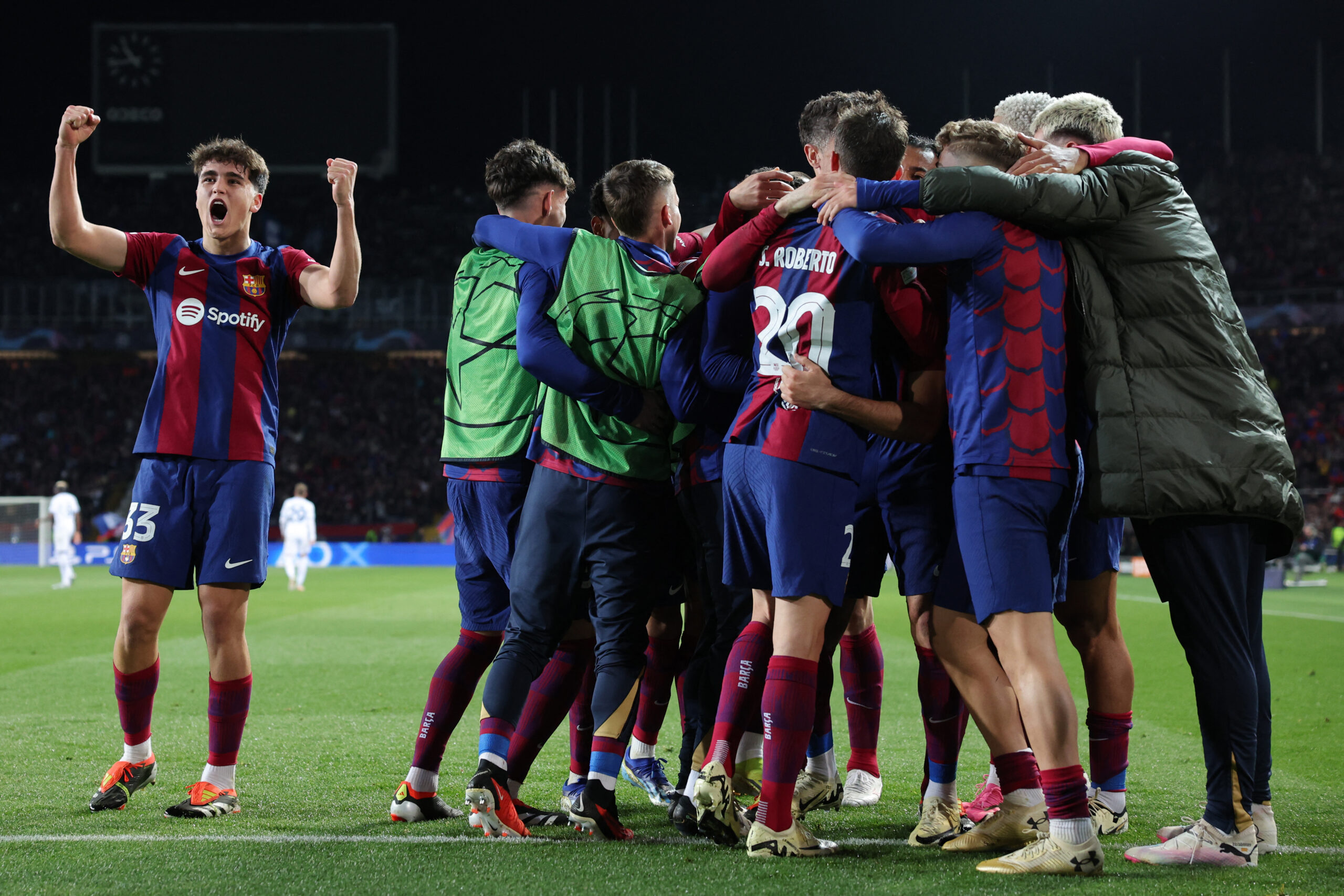 Barcelona players celebrate their third goal scored by Barcelona's Polish forward #09 Robert Lewandowski during the UEFA Champions League last 16 second leg football match between FC Barcelona and SSC Napoli at the Estadi Olimpic Lluis Companys in Barcelona on March 12, 2024.