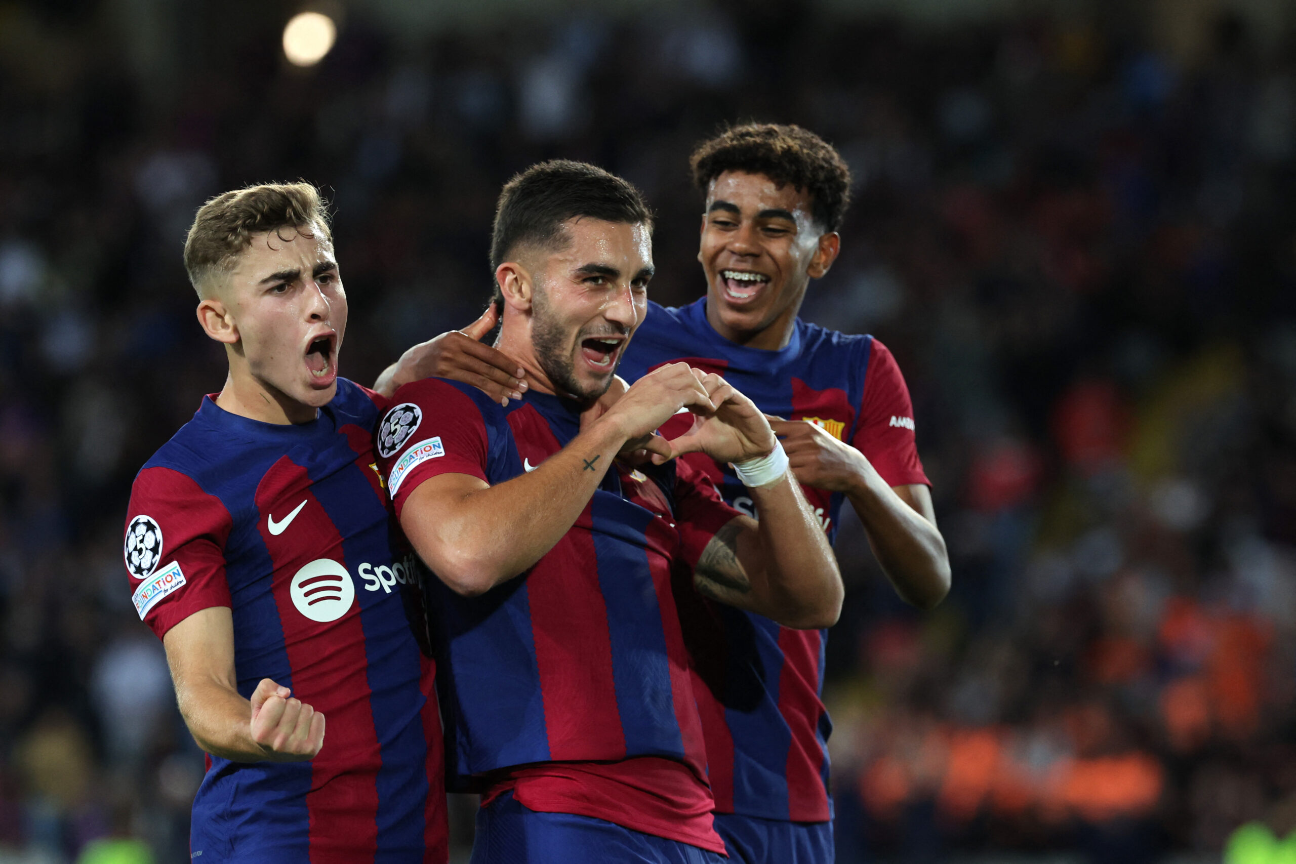 Barcelona's Spanish forward #07 Ferran Torres (C), flanked by Barcelona's Spanish midfielder #32 Fermin Lopez (L) and Barcelona's Spanish forward #27 Lamine Yamal, celebrates scoring the opening goal during the UEFA Champions League 1st round Group H football match between FC Barcelona and Shakhtar Donetsk at the Estadi Olimpic Lluis Companys in Barcelona on October 25, 2023.