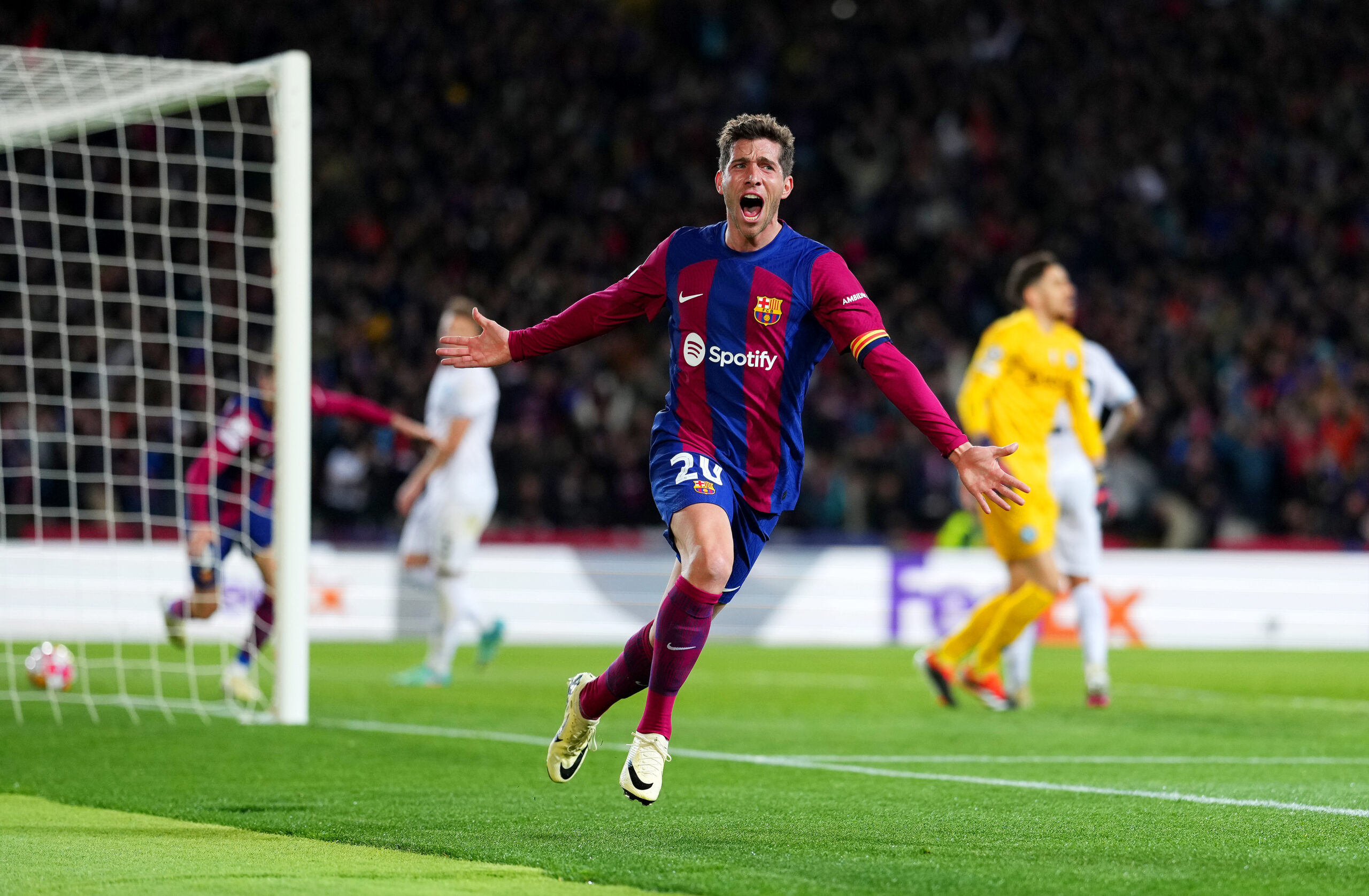 BARCELONA, SPAIN - MARCH 12: Sergi Roberto of FC Barcelona celebrates after Robert Lewandowski of FC Barcelona (not pictured) scores his team's third goal during the UEFA Champions League 2023/24 round of 16 second leg match between FC Barcelona and SSC Napoli at Estadi Olimpic Lluis Companys on March 12, 2024 in Barcelona, Spain.