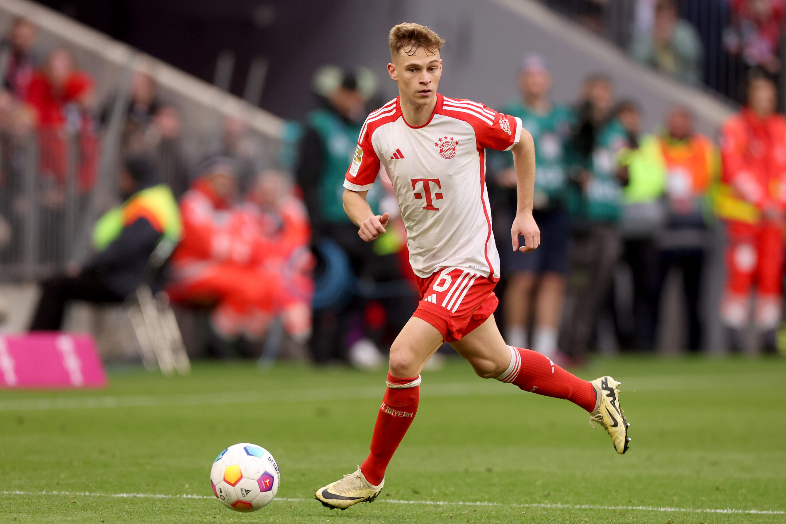 MUNICH, GERMANY - MARCH 09: Joshua Kimmich of FC Bayern München runs with the ball during the Bundesliga match between FC Bayern München and 1. FSV Mainz 05 at Allianz Arena on March 09, 2024 in Munich, Germany.