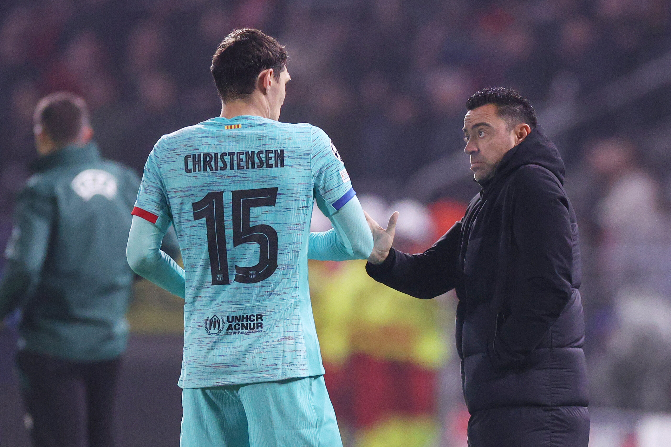 ANTWERPEN, BELGIUM - DECEMBER 13: Andreas Christensen of FC Barcelona talks to Xavi, Head Coach of FC Barcelona, during the UEFA Champions League match between Royal Antwerp and FC Barcelona at Bosuilstadion on December 13, 2023 in Antwerpen, Belgium.