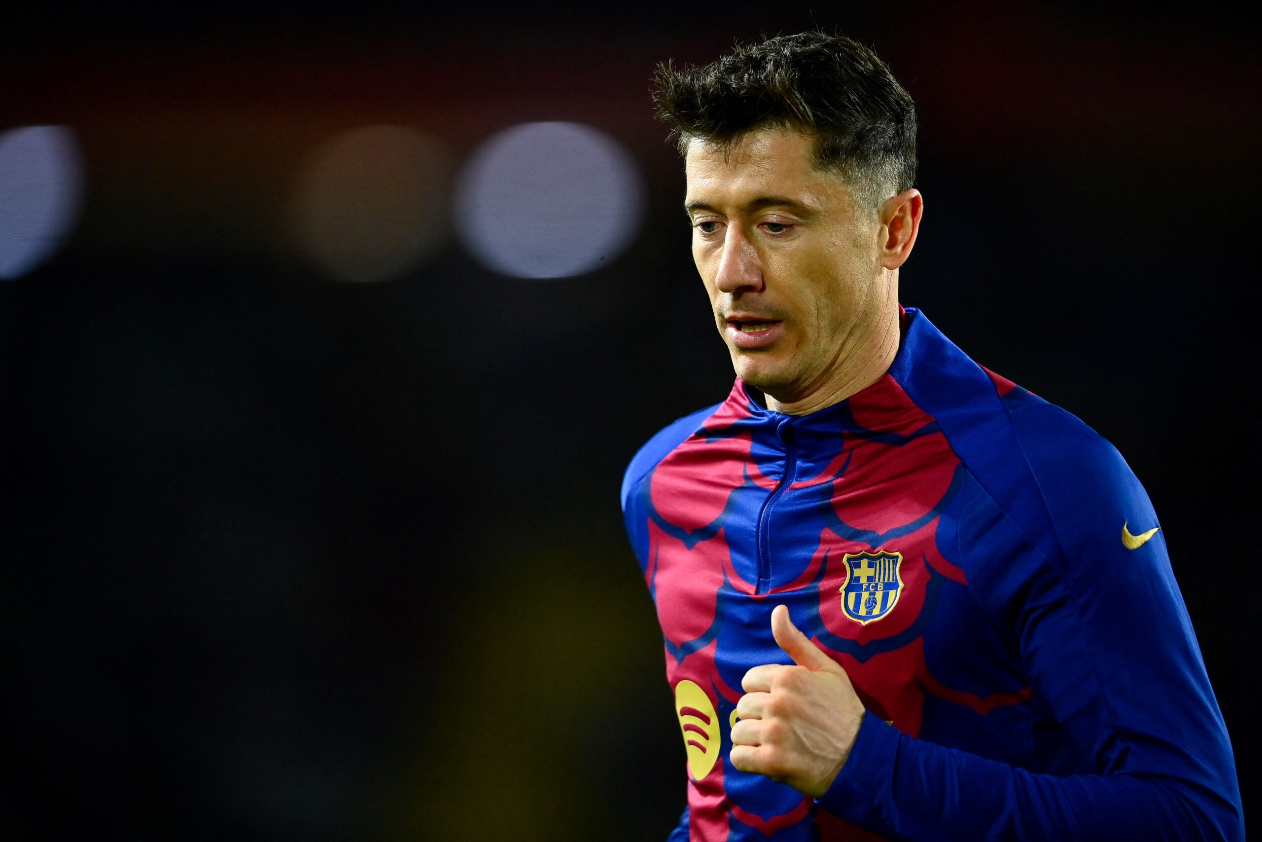 Barcelona's Polish forward #09 Robert Lewandowski warms up before the start of the Spanish league football match between FC Barcelona and UD Las Palmas at the Estadi Olimpic Lluis Companys in Barcelona on March 30, 2024.