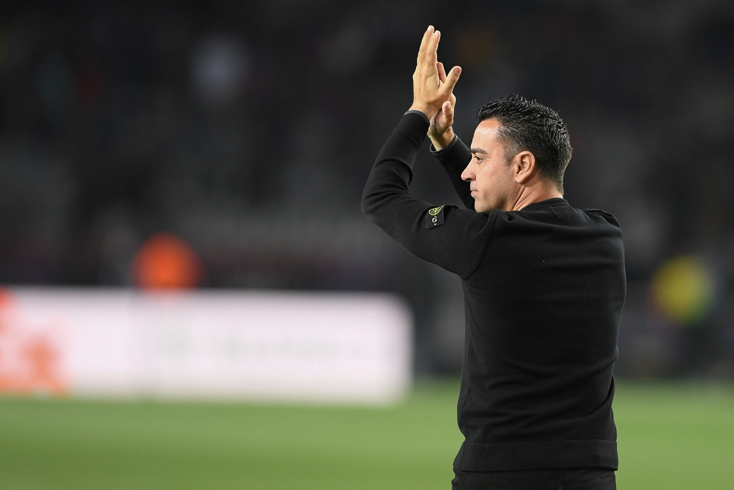 Barcelona's Spanish coach Xavi applauds at the end of the UEFA Champions League quarter-final second leg football match between FC Barcelona and Paris SG at the Estadi Olimpic Lluis Companys in Barcelona on April 16, 2024.