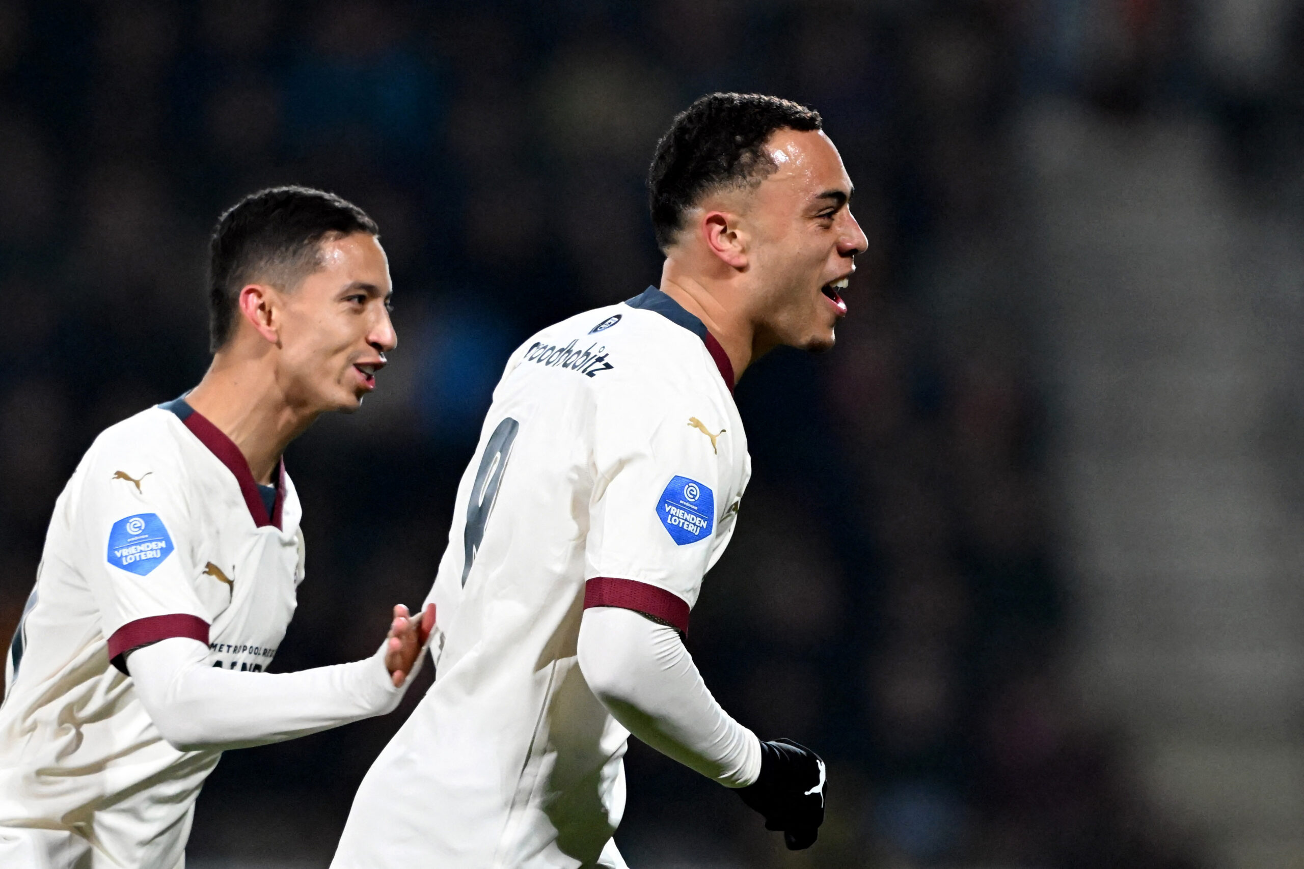 PSV's US midfielder #08 Sergino Dest (R) celebrates scoring his team's first goal with teammate PSV's Brazilian defender #17 Mauro Junior (L) during the Dutch Eredivisie football match between Go Ahead Eagles and PSV Eindhoven at De Adelaarshorst stadium in Deventer on March 8, 2024.