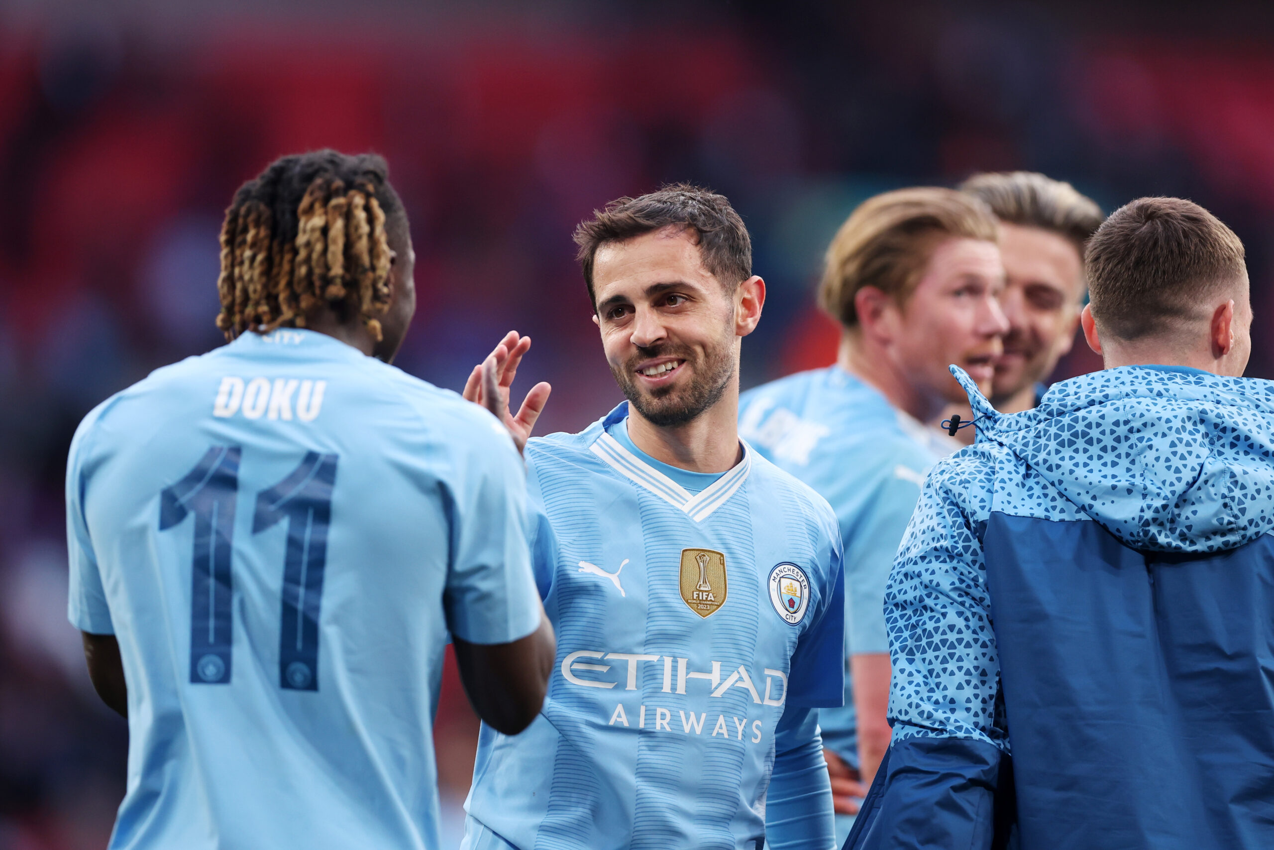 LONDON, ENGLAND - APRIL 20: Bernardo Silva and Jeremy Doku of Manchester City celebrate after the team's victory during the Emirates FA Cup Semi Final match between Manchester City and Chelsea at Wembley Stadium on April 20, 2024 in London, England.