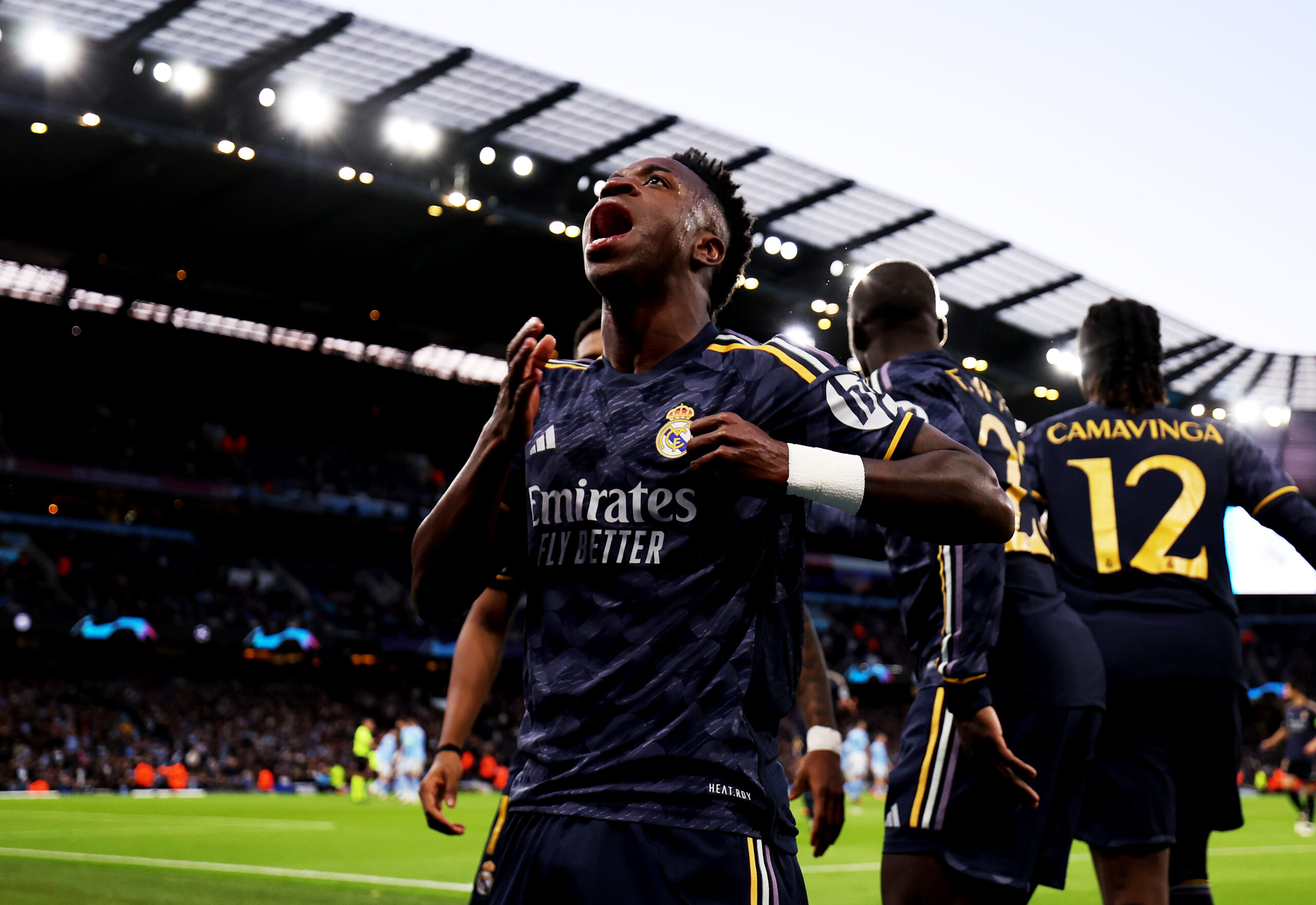 MANCHESTER, ENGLAND - APRIL 17: Vinicius Junior of Real Madrid celebrates his team's first goal scored by teammate Rodrygo (not pictured) during the UEFA Champions League quarter-final second leg match between Manchester City and Real Madrid CF at Etihad Stadium on April 17, 2024 in Manchester, England.