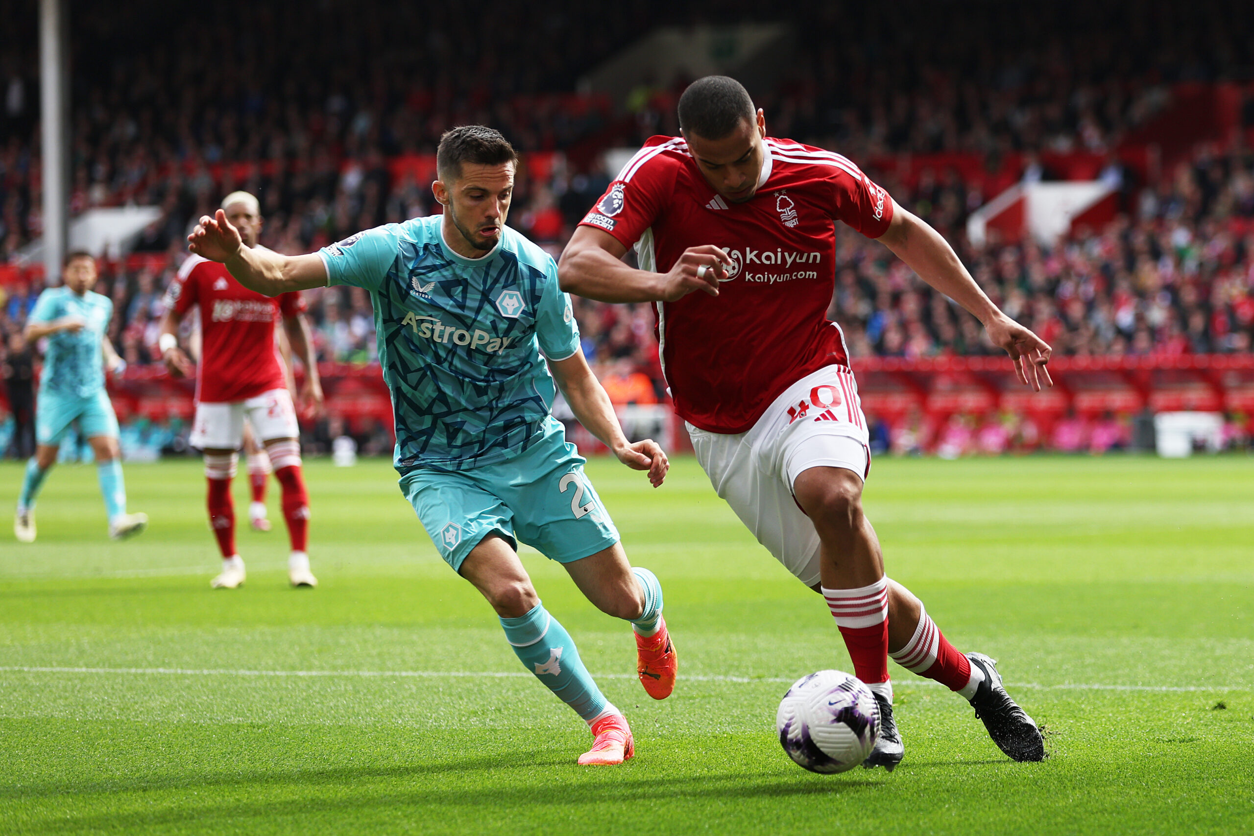 NOTTINGHAM, ENGLAND - APRIL 13: Murillo of Nottingham Forest runs with the ball under pressure from Pablo Sarabia of Wolverhampton Wanderers during the Premier League match between Nottingham Forest and Wolverhampton Wanderers at City Ground on April 13, 2024 in Nottingham, England.