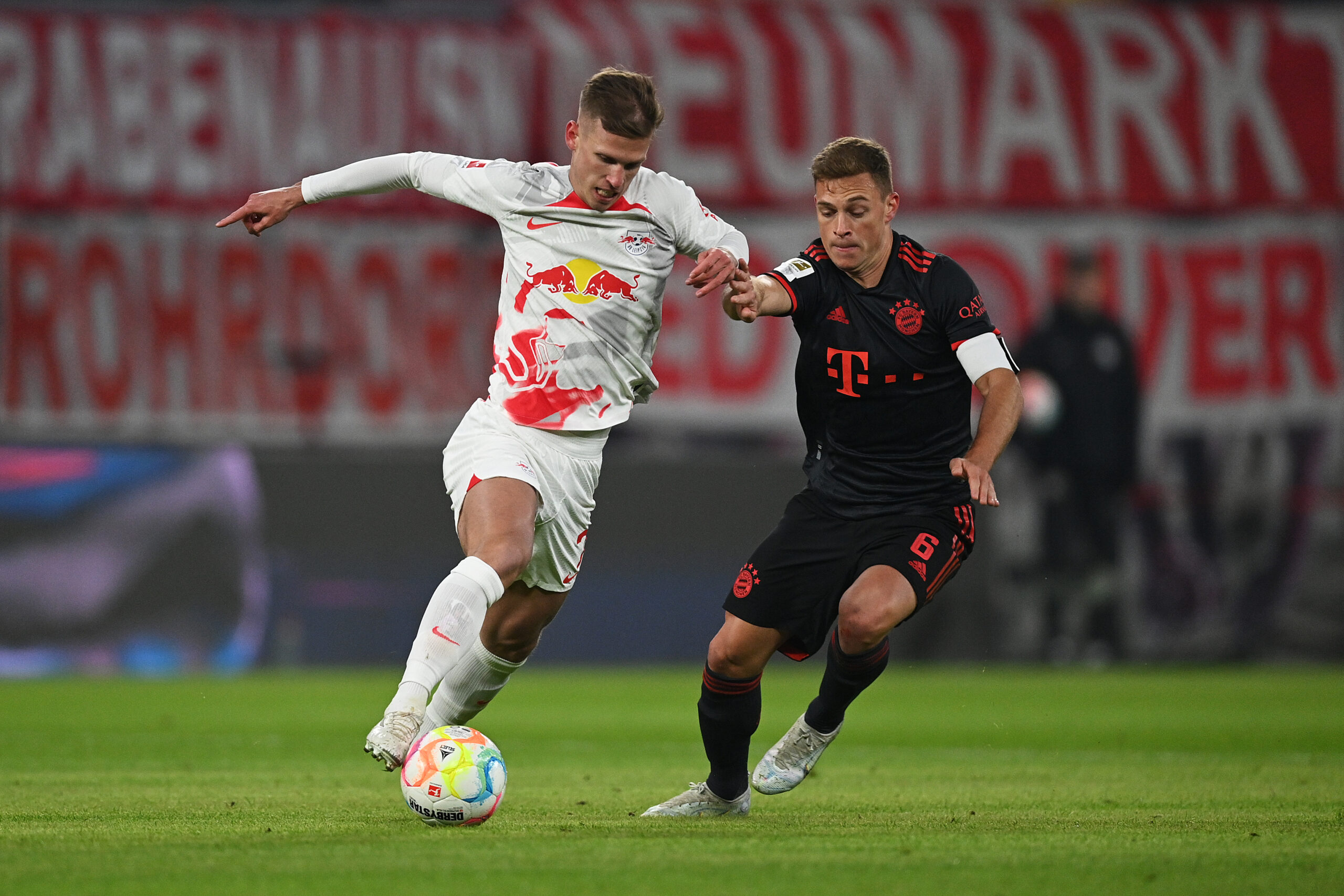 LEIPZIG, GERMANY - JANUARY 20: Dani Olmo of RB Leipzig battles for possession with Joshua Kimmich of Bayern Munich during the Bundesliga match between RB Leipzig and FC Bayern Muenchen at Red Bull Arena on January 20, 2023 in Leipzig, Germany.