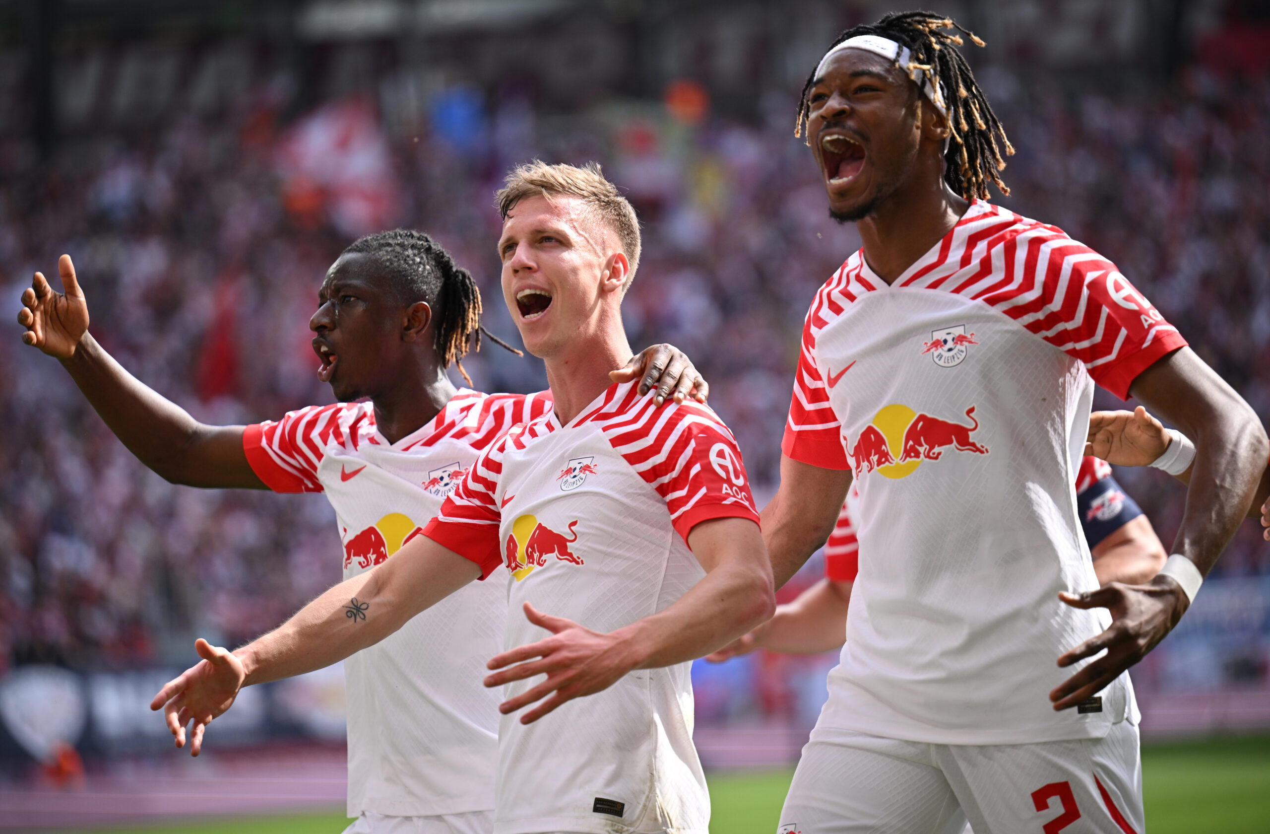 LEIPZIG, GERMANY - APRIL 13: Dani Olmo of RB Leipzig celebrates scoring his team's first goal with teammates Amadou Haidara and Mohamed Simakan during the Bundesliga match between RB Leipzig and VfL Wolfsburg at Red Bull Arena on April 13, 2024 in Leipzig, Germany.