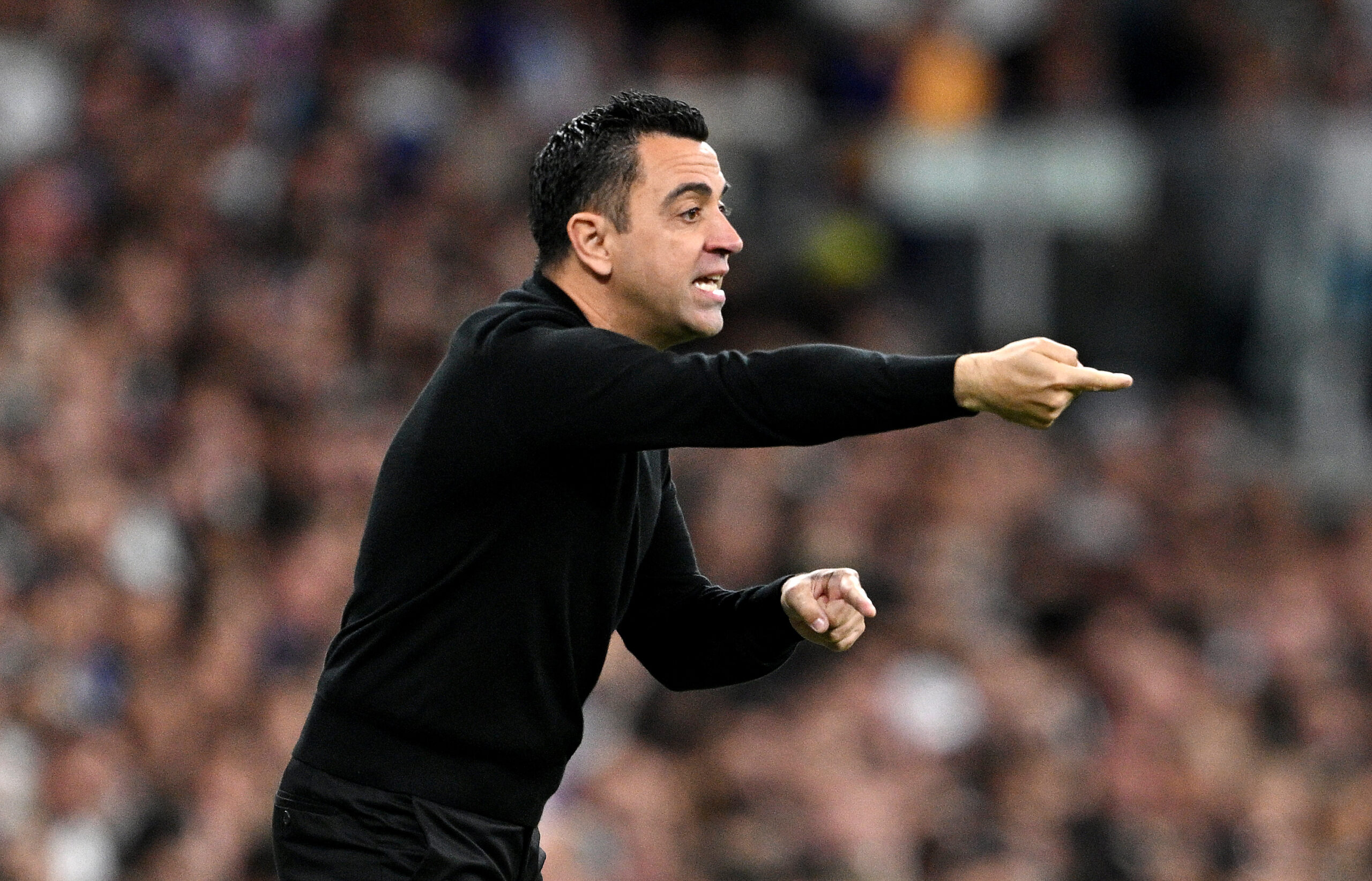 MADRID, SPAIN - APRIL 21: Xavi, Head Coach of FC Barcelona, gives the team instructions during the LaLiga EA Sports match between Real Madrid CF and FC Barcelona at Estadio Santiago Bernabeu on April 21, 2024 in Madrid, Spain.
