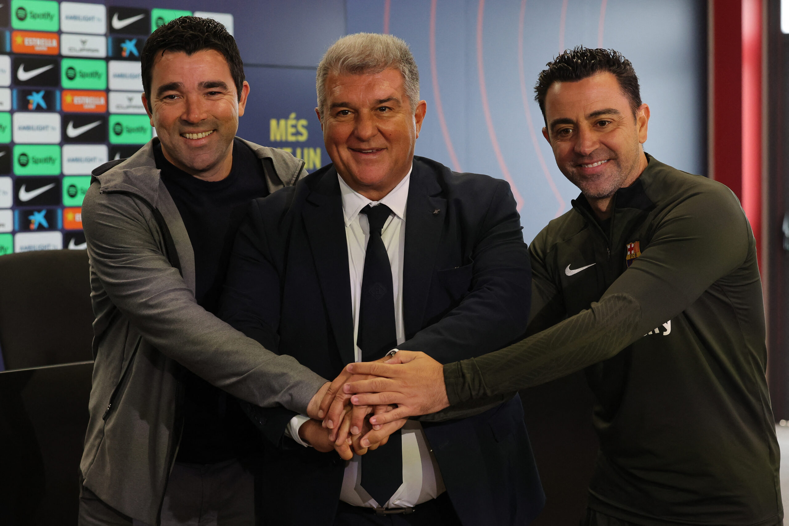 TOPSHOT - (From L) Barcelona's Sports Director Anderson de Souza "Deco", FC Barcelona President Joan Laporta and Barcelona's Spanish coach Xavi pose for pictures before a press conference at the Joan Gamper training ground in Sant Joan Despi, near Barcelona, on April 25, 2024. Xavi will remain as coach of Barcelona, the Spanish giants told AFP on April 24, despite having announced in January that he planned to quit at the end of the season due to the "cruel and unpleasant" nature of the job.