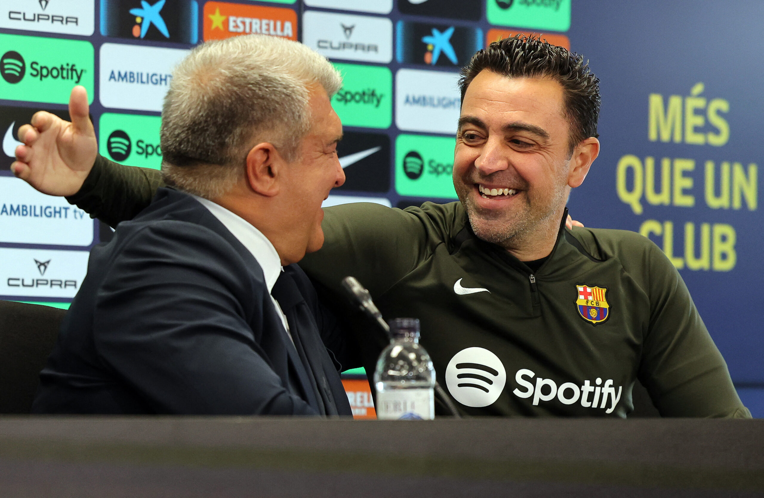 TOPSHOT - FC Barcelona President Joan Laporta (L) and Barcelona's Spanish coach Xavi react during a press conference at the Joan Gamper training ground in Sant Joan Despi, near Barcelona, on April 25, 2024. Xavi will remain as coach of Barcelona, the Spanish giants told AFP on April 24, despite having announced in January that he planned to quit at the end of the season due to the "cruel and unpleasant" nature of the job.