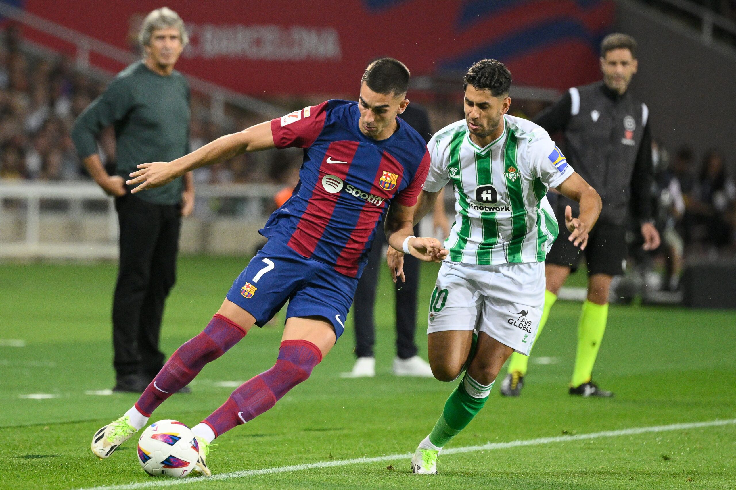 Barcelona's Spanish forward #07 Ferran Torres fights for the ball with Real Betis' Spanish midfielder #10 Ayoze Perez during the Spanish Liga football match between FC Barcelona and Real Betis at the Estadi Olimpic Lluis Companys in Barcelona on September 16, 2023.